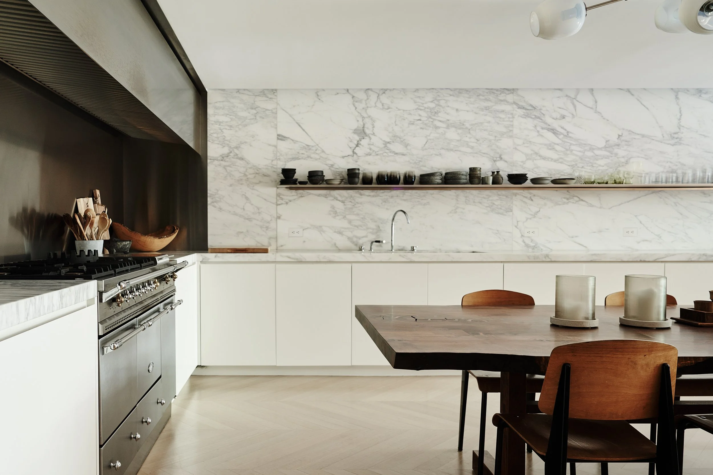 marble kitchen walls with wooden floors and dining area  in fabien barons west village townhouse by JGNA