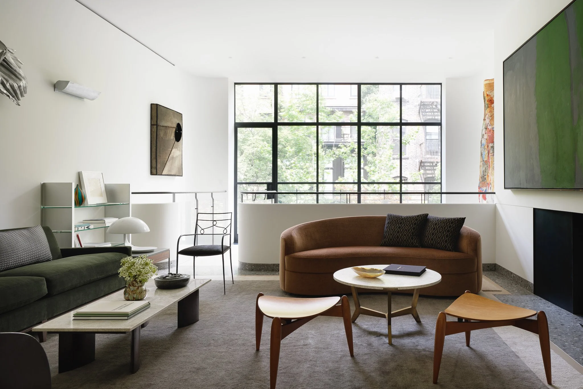 Mezzanine sitting area overlooking the double-height living room in a West Village townhouse by JG Neukomm Architecture