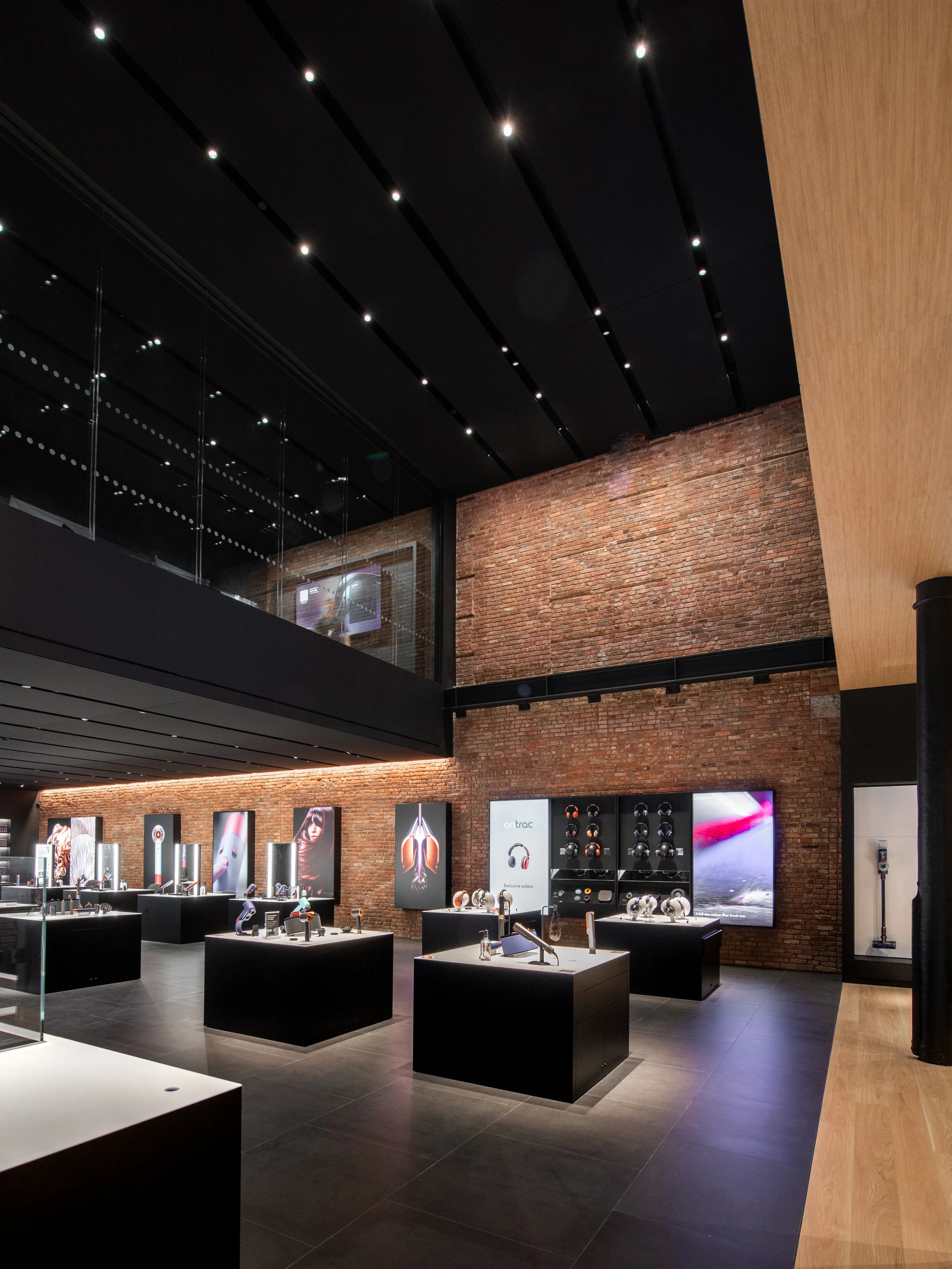Dyson Demo Store mezzanine view looking down onto the display floor and brick interior