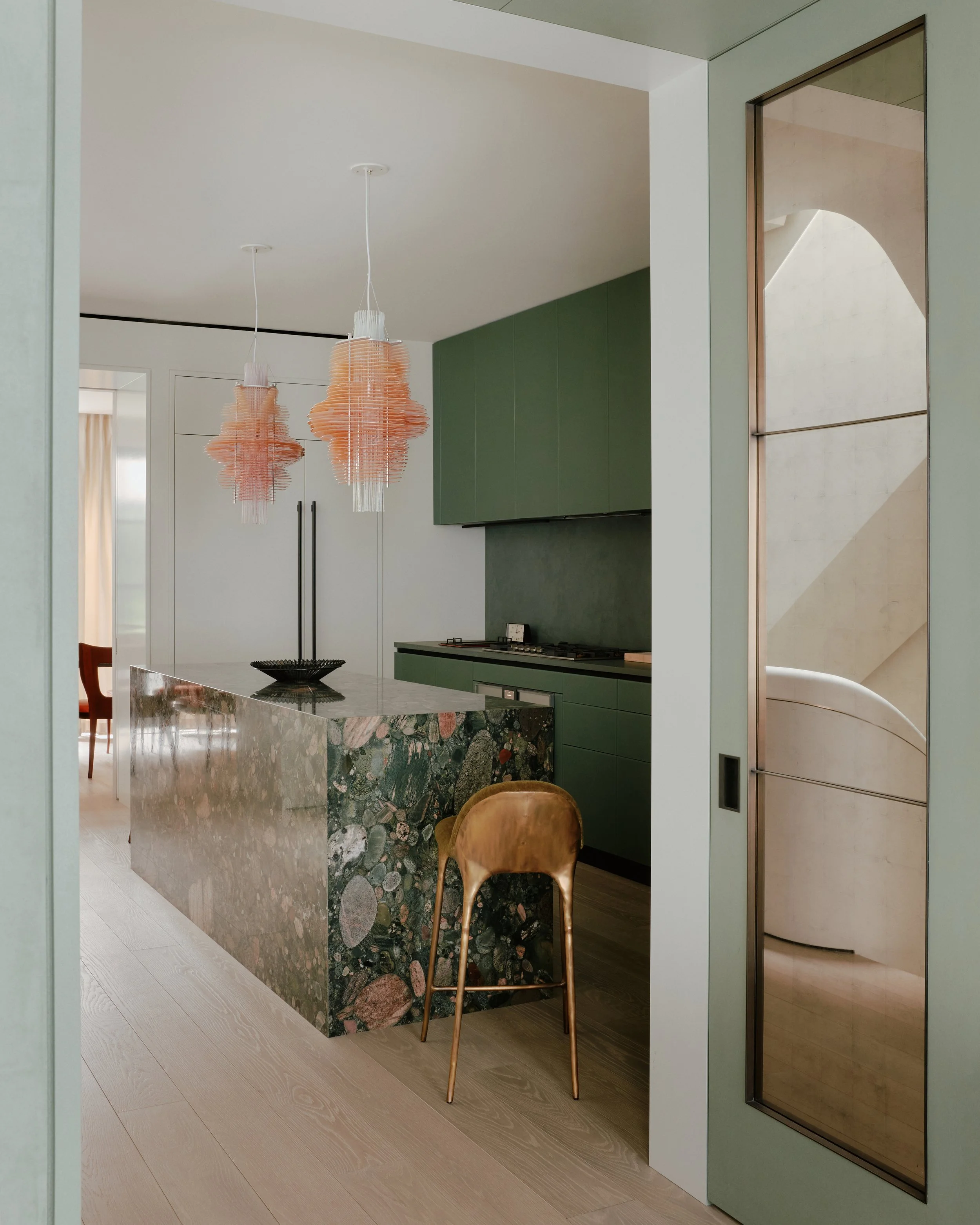 Kitchen island in conglomerate stone with bar seating in a West Village townhouse by JG Neukomm Architecture