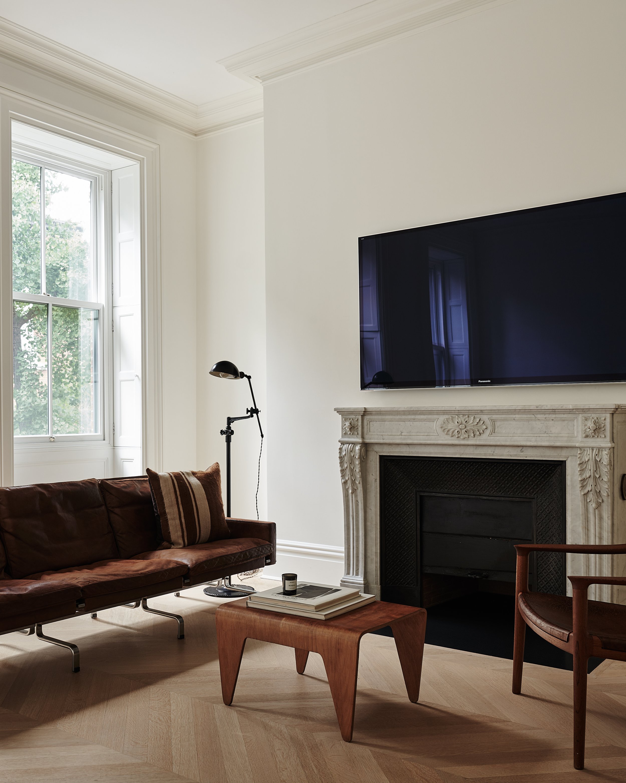 view of seating area and tv in west village townhouse by JGNA