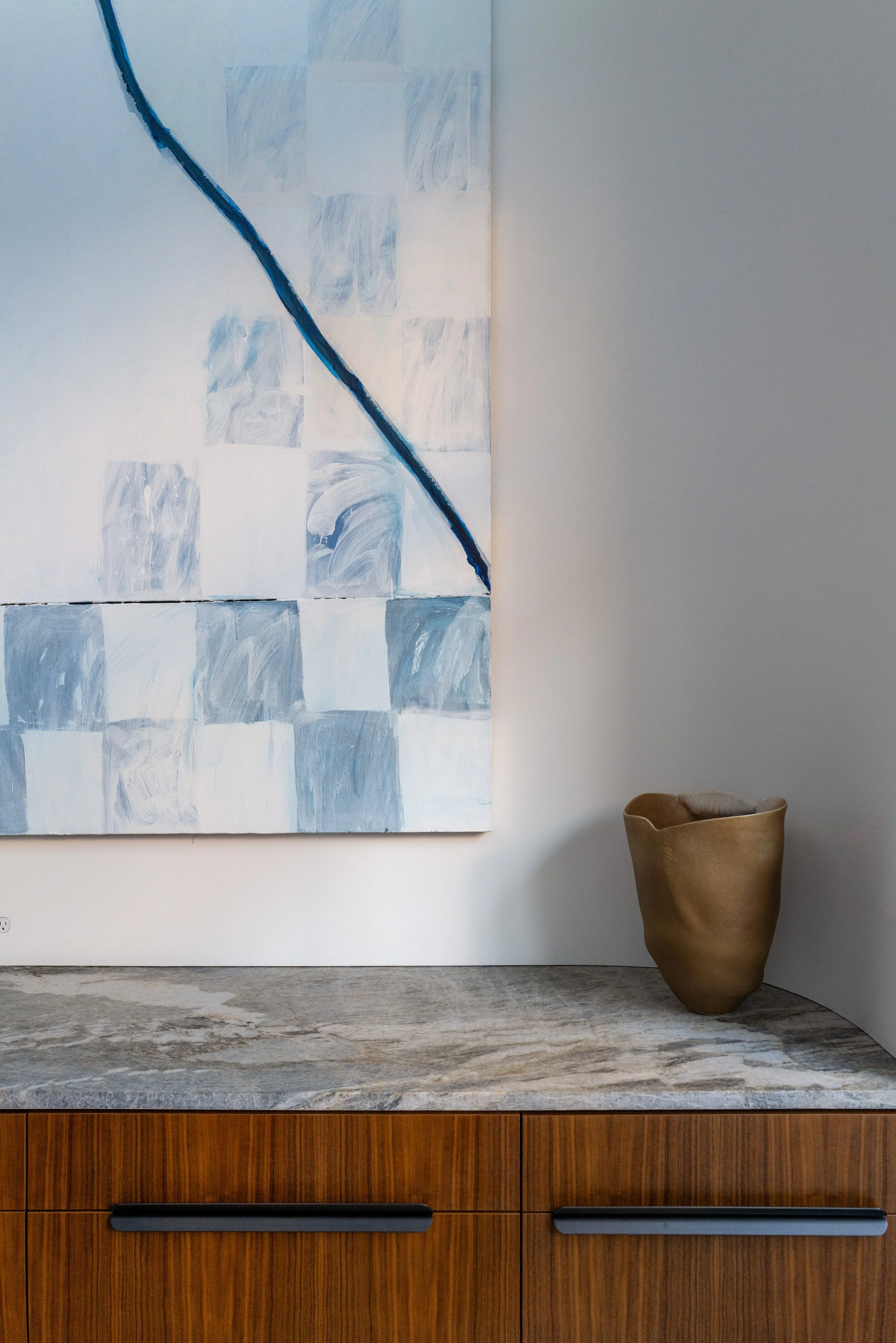 Stone counter beneath a contemporary painting in a West Village townhouse by JG Neukomm Architecture