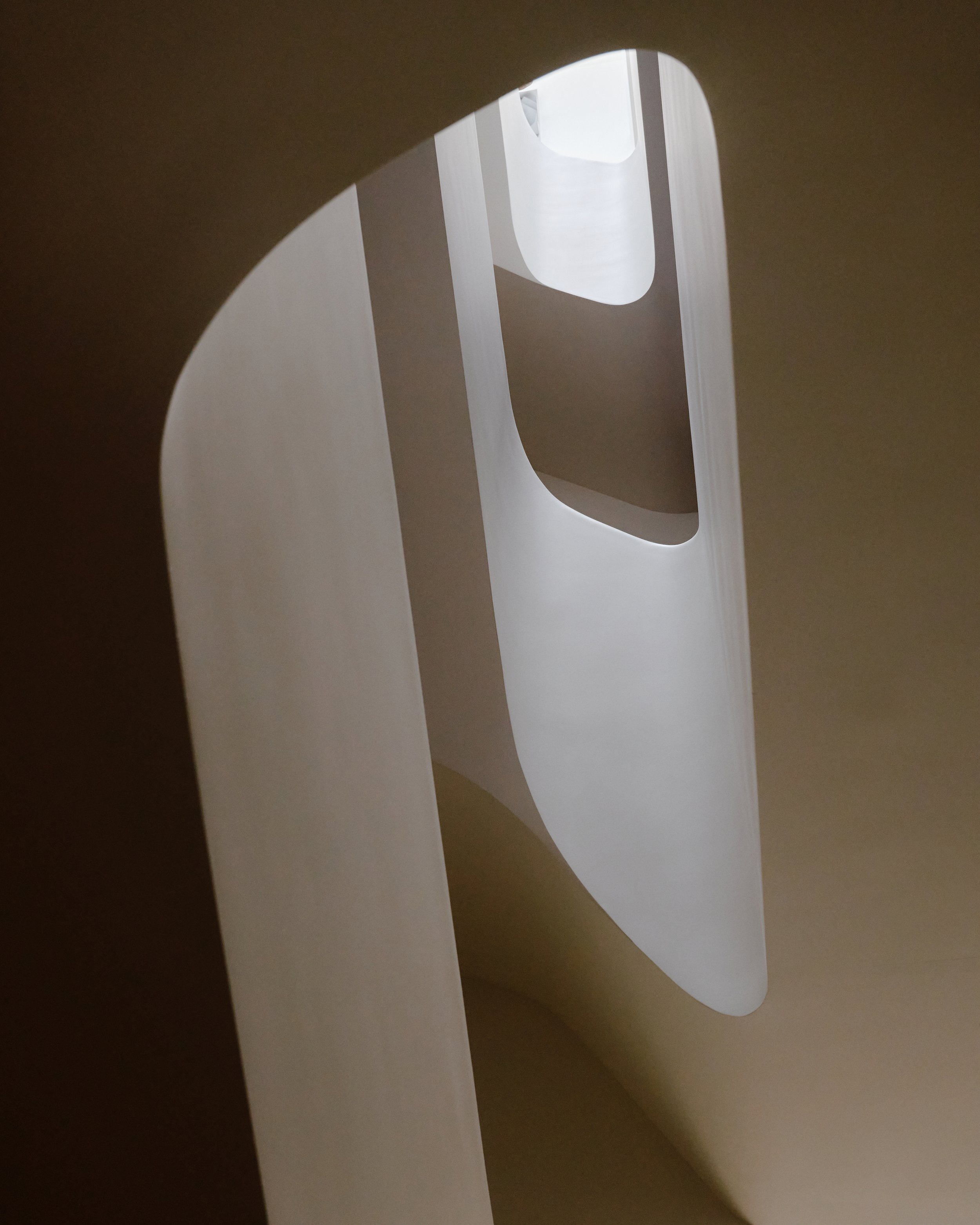 Sculptural white plaster curves of the staircase in a West Village townhouse by JG Neukomm Architecture