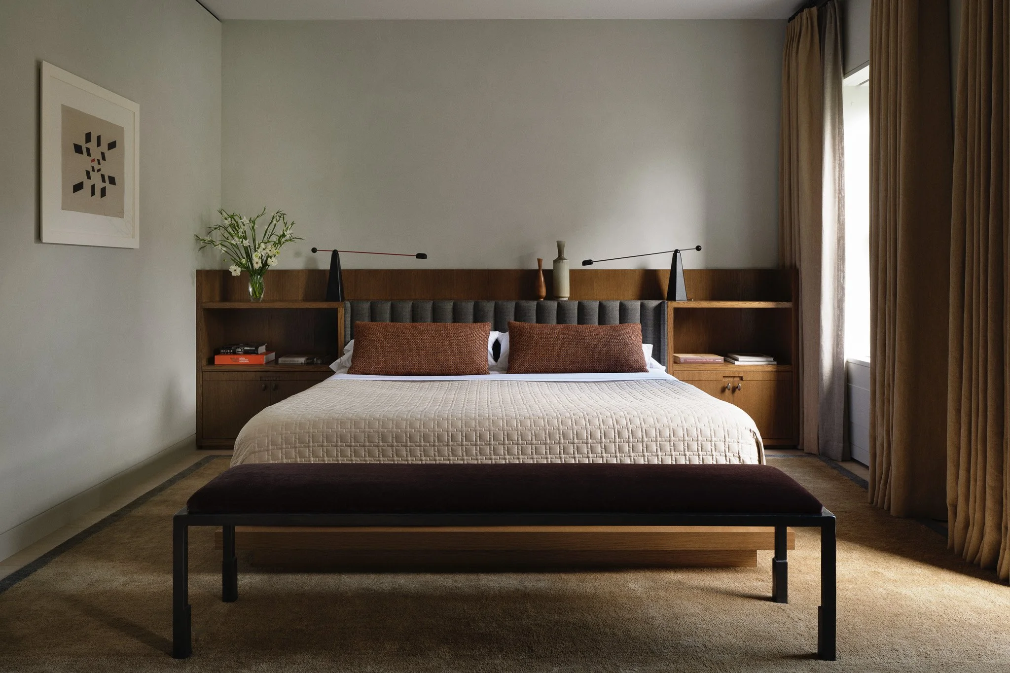 Primary bedroom with a tufted headboard and built-in oak nightstands in a West Village townhouse by JG Neukomm Architecture