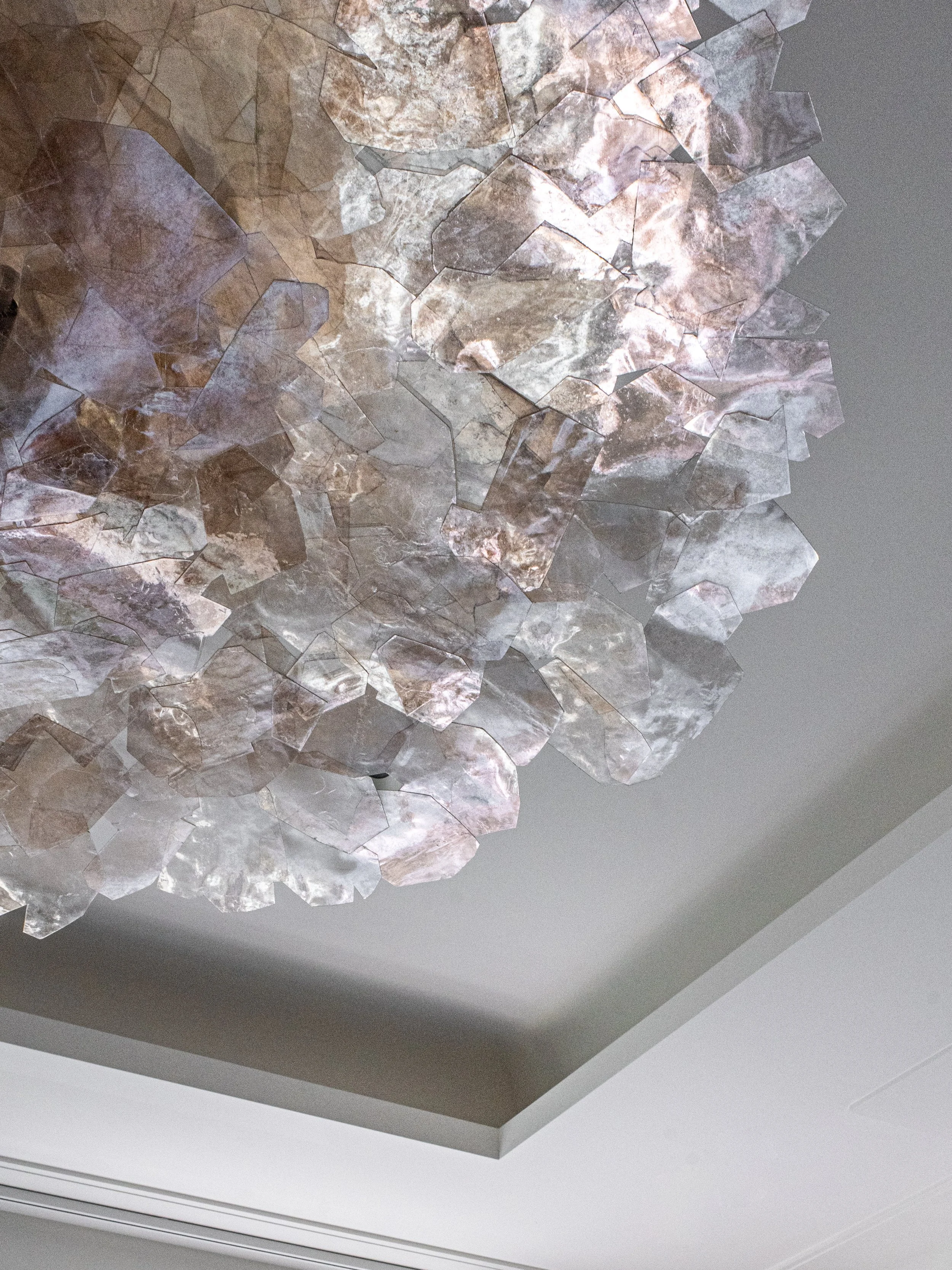 tray-ceiling-detail.jpgTranslucent rock crystal chandelier viewed from below against a stepped tray ceiling