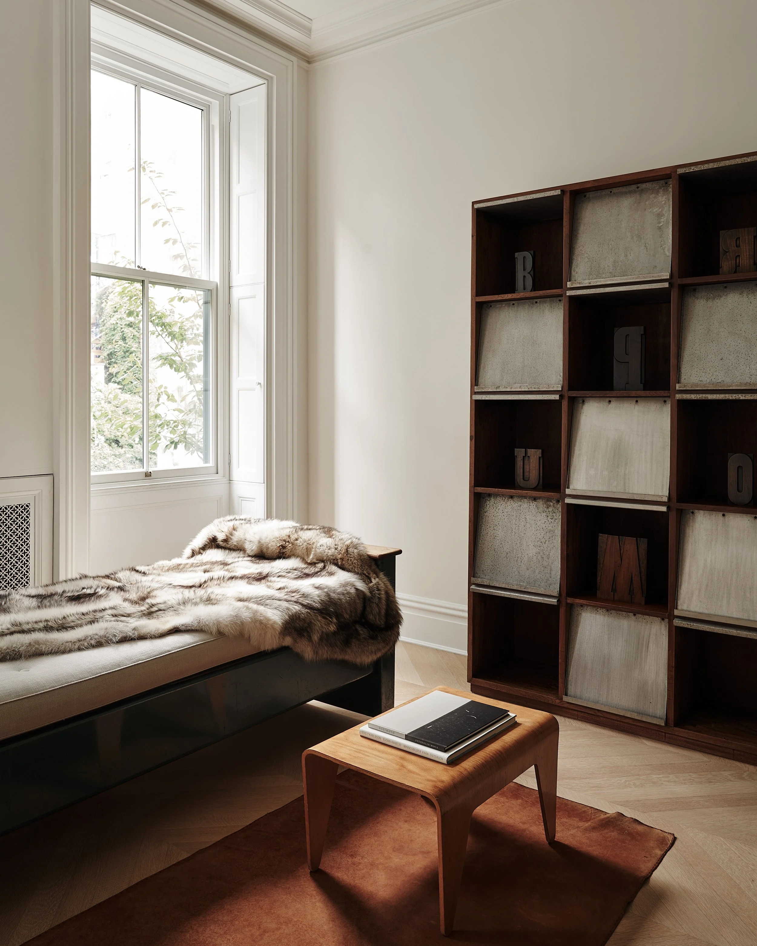 shelving and seating area  in fabien barons west village townhouse by JGNA