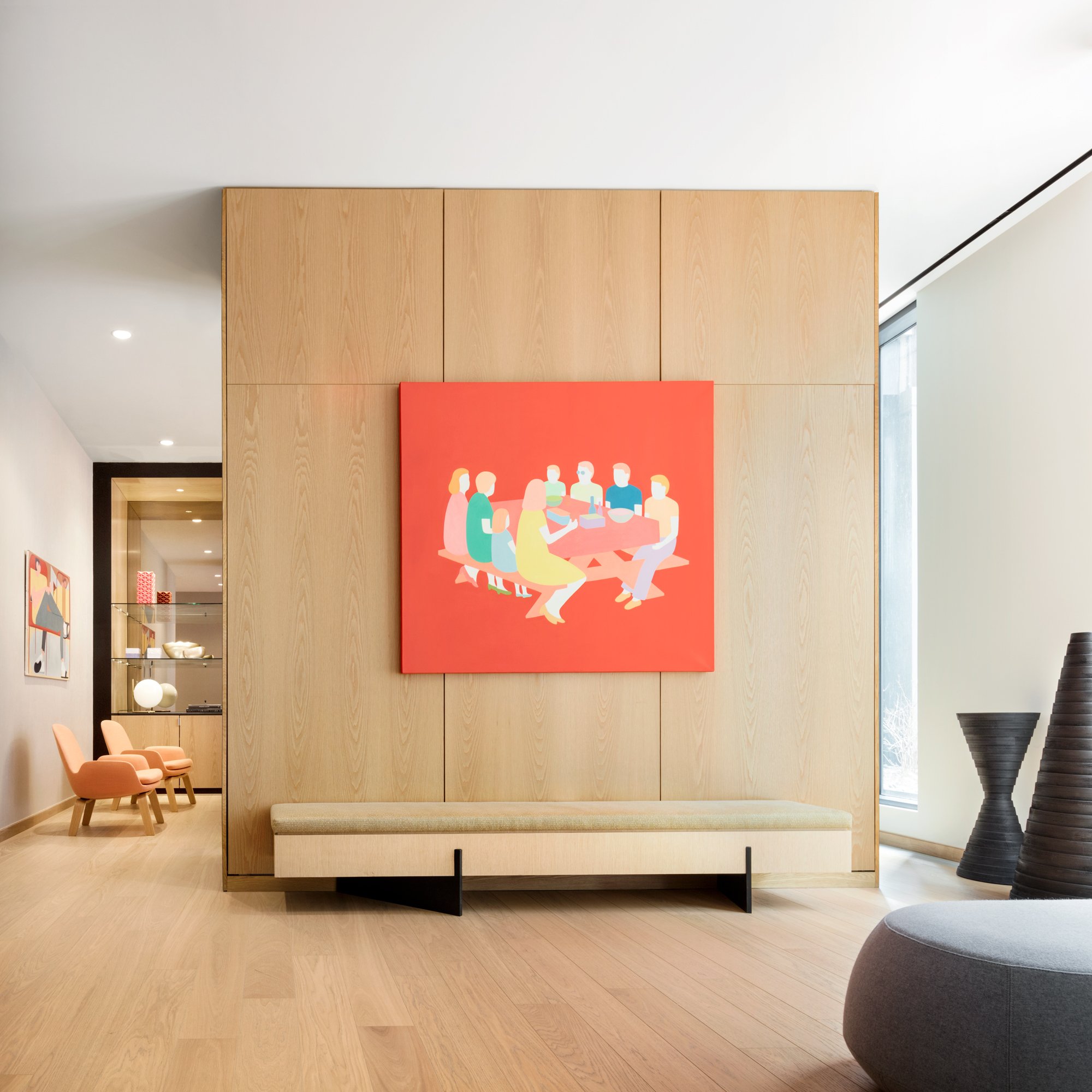 JGNA residential lounge with an oak feature wall, a red figurative painting, and a built-in bench