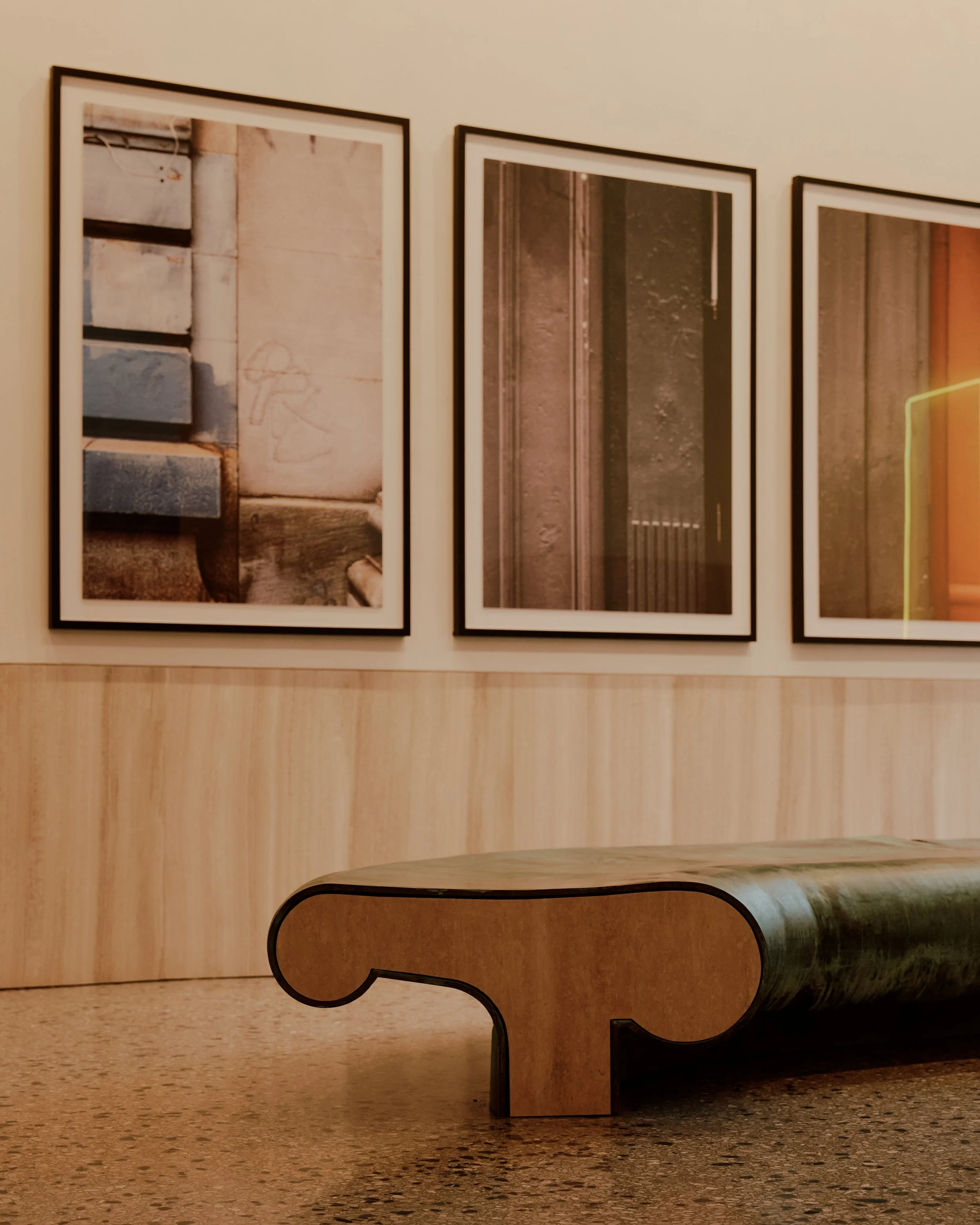 Detail view of custom curved bench seating and art program at The Suffolk elevated residential building by JGNA
