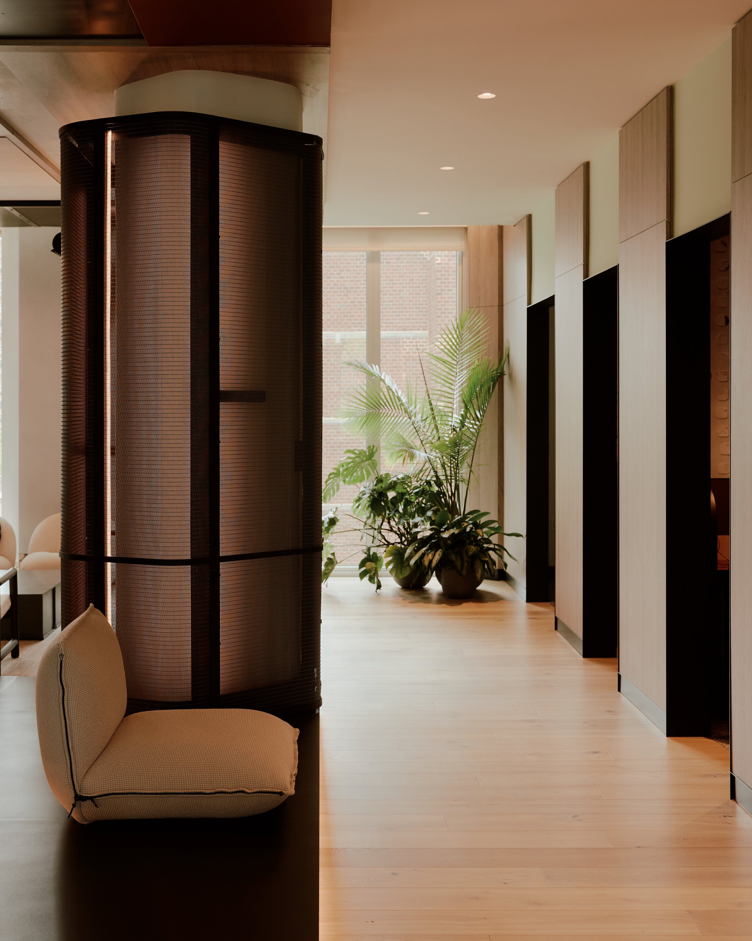 Amenity space at The Suffolk designed by JGNA featuring natural light, custom architectural detailing, and biophilic interior elements