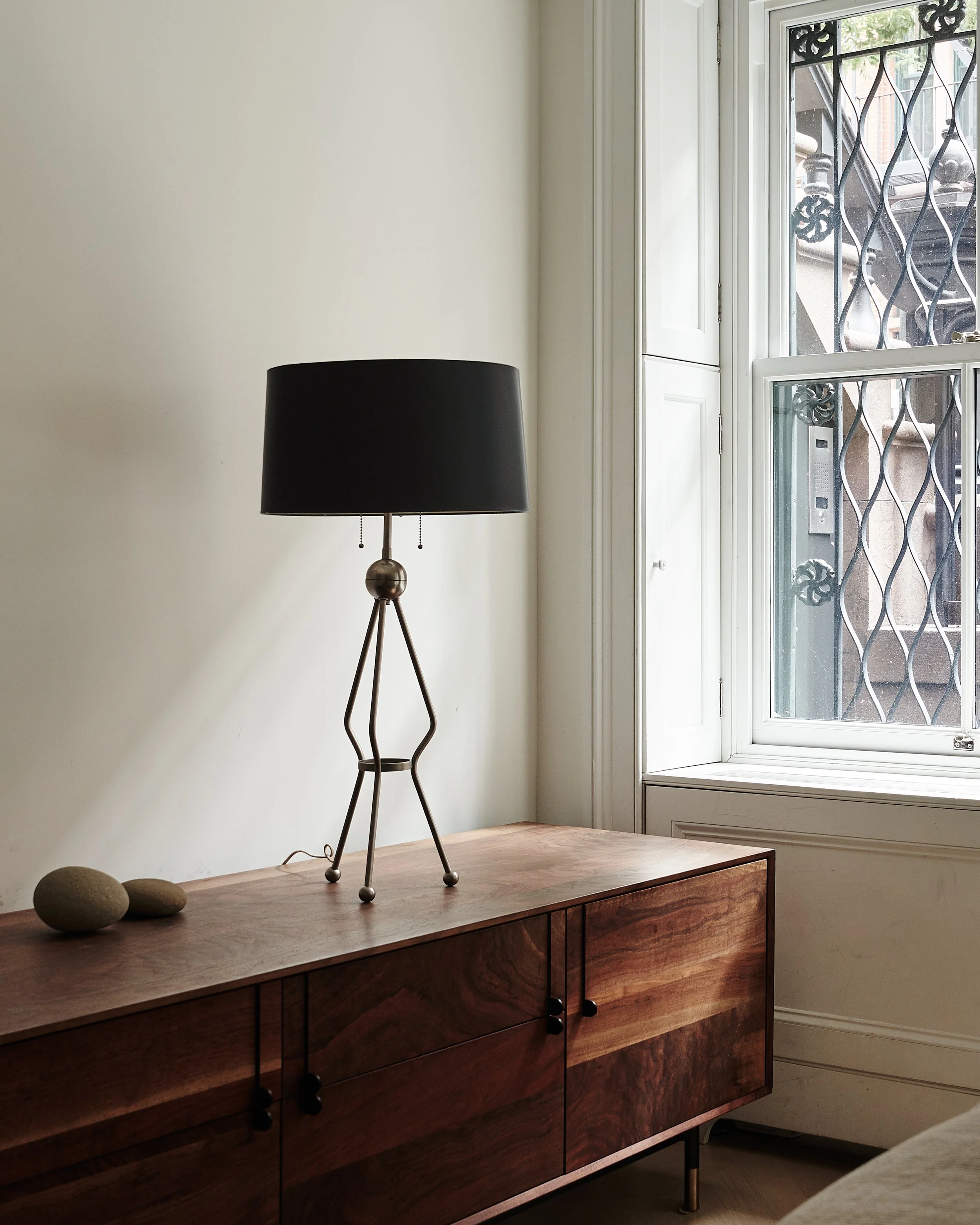 dark wood table next to window in a west village townhouse by JGNA