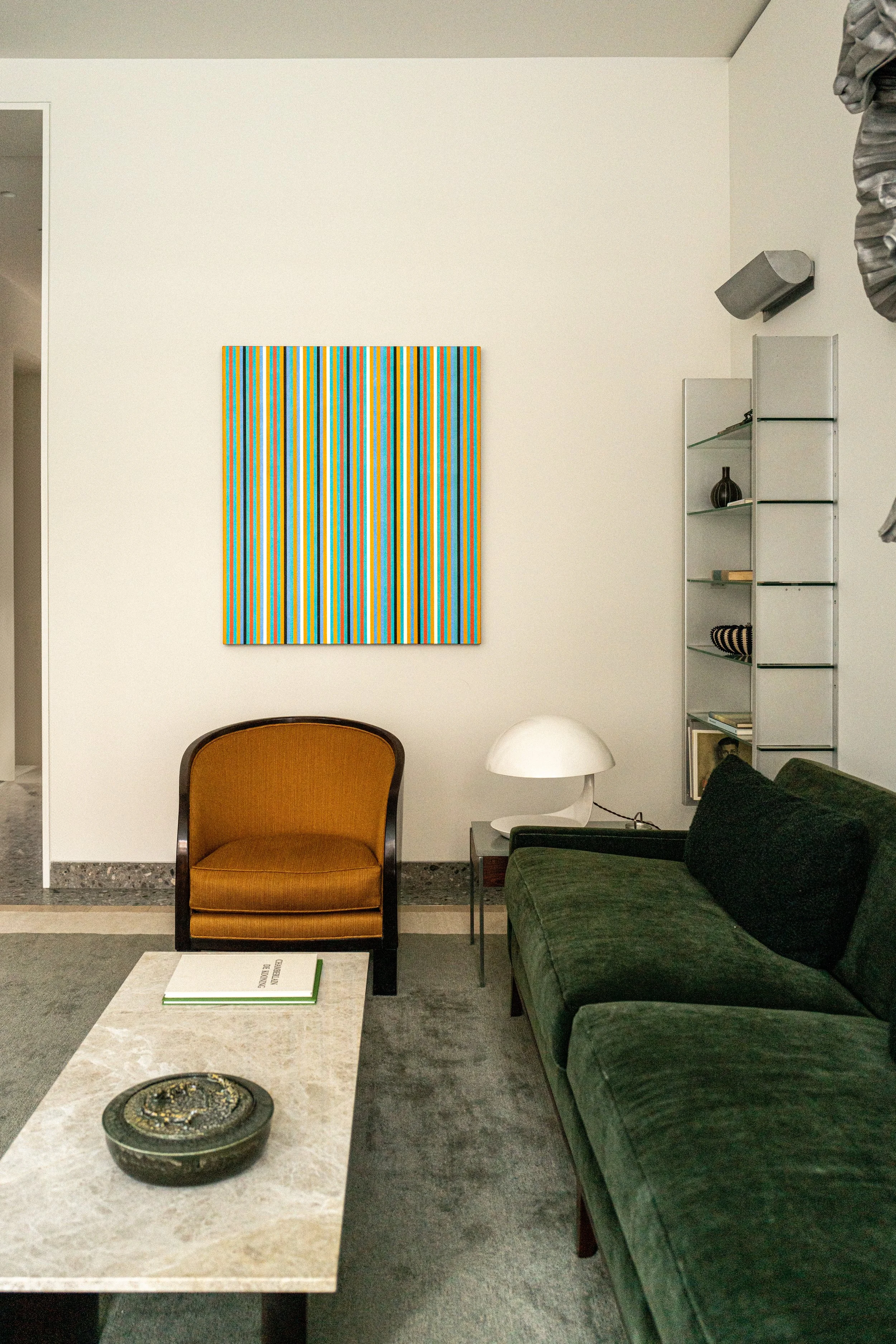 Sitting room with a green velvet sofa and a striped contemporary painting in a West Village townhouse by JG Neukomm Architecture