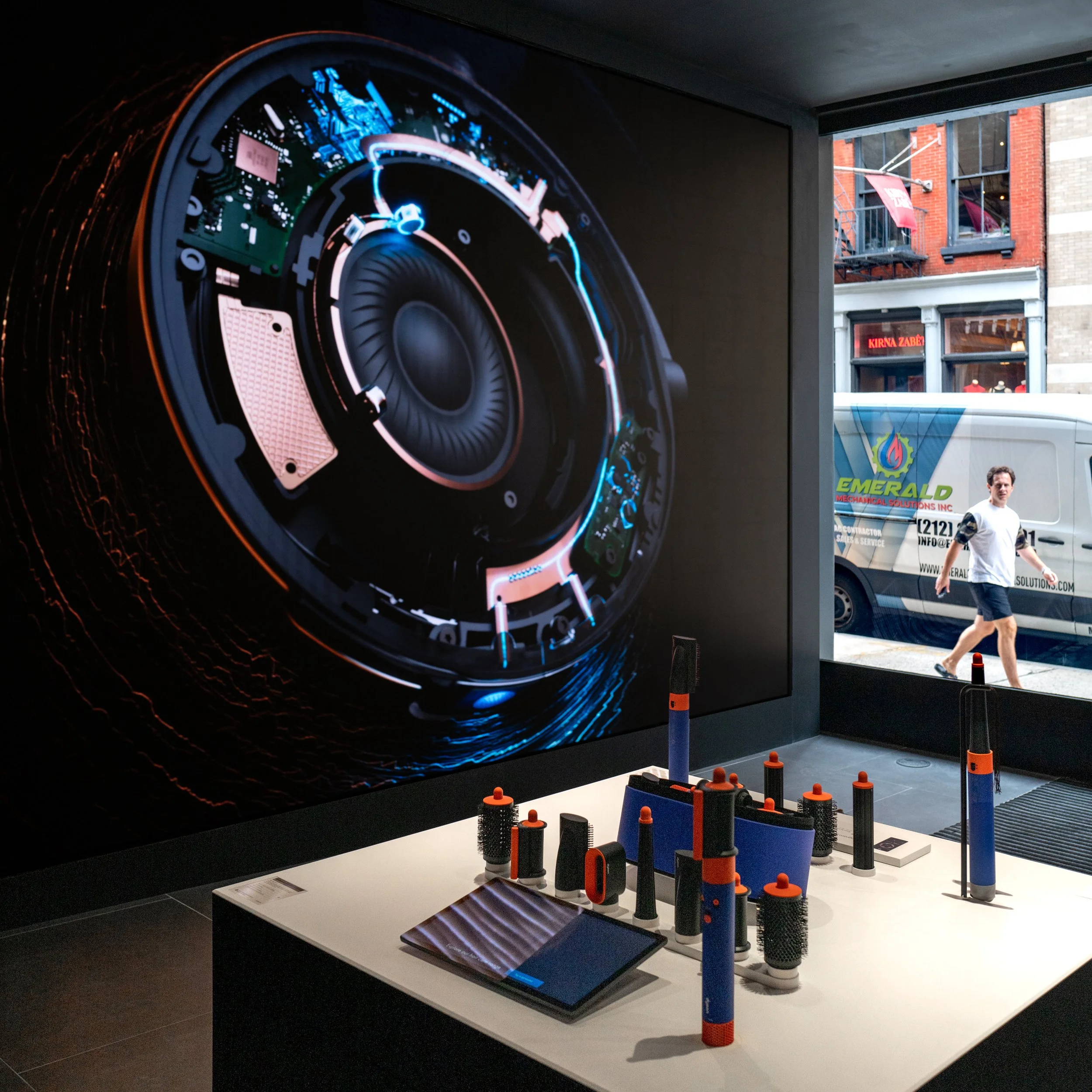 Dyson Demo Store display with a large product cutaway screen above a hair styling counter