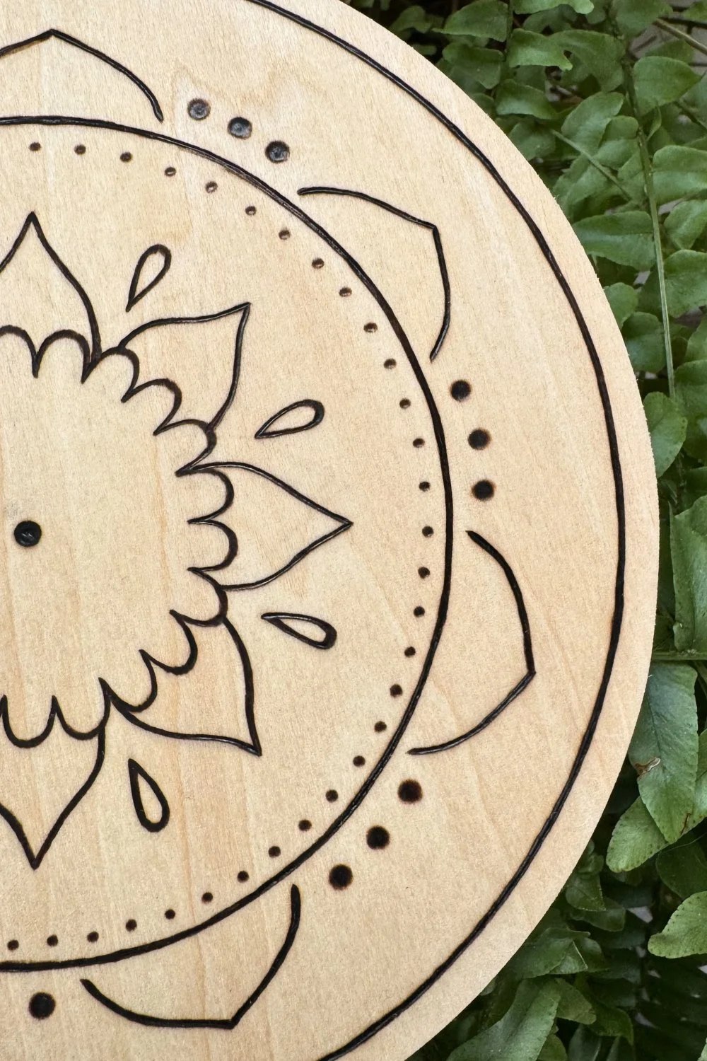 Hand-burned mandala artwork “Still” by Cheyenne Wenske, pyrography on birch panel.