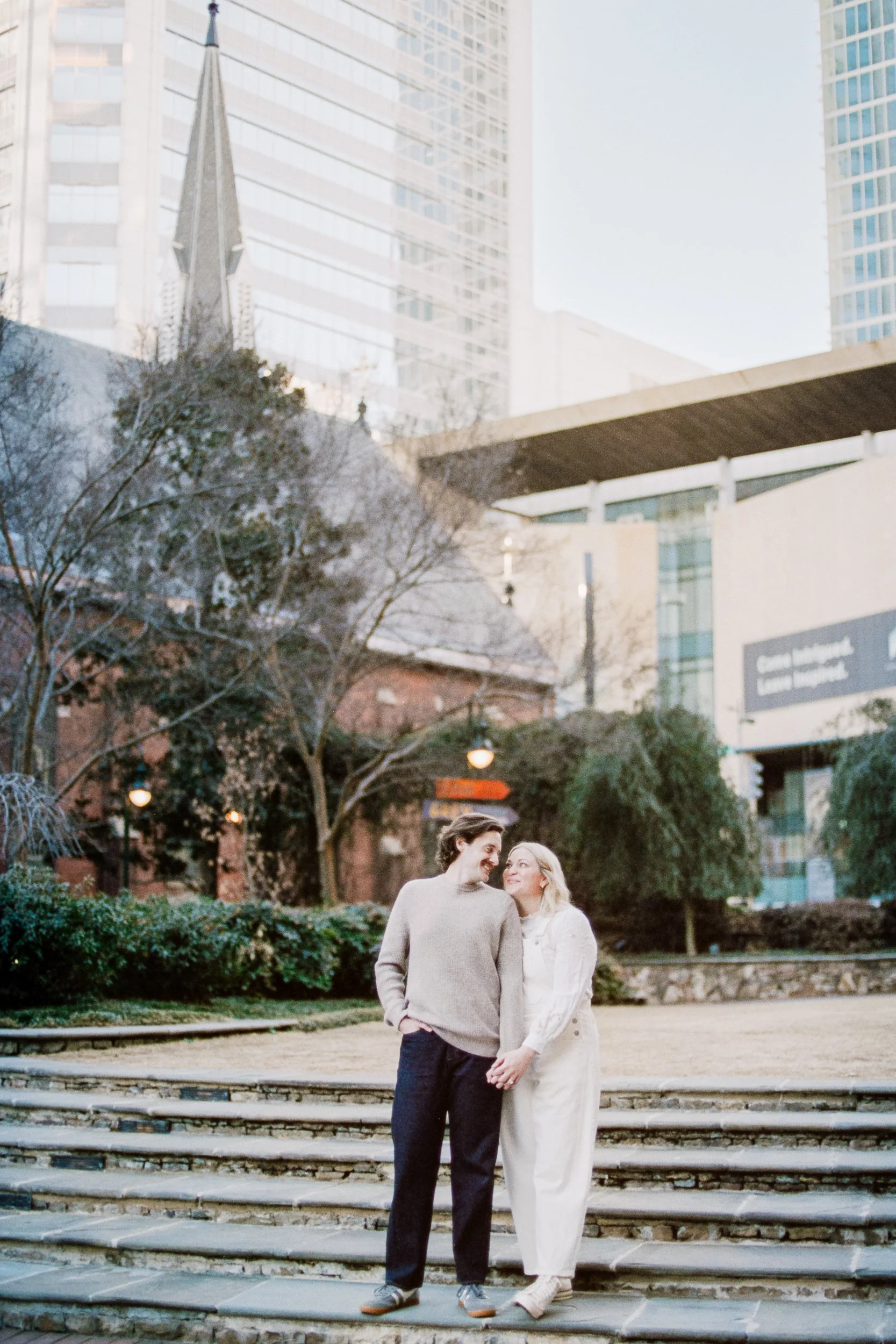 Film Engagement Photos on The Green Uptown Charlotte St Peter Catholic Church by wedding photographer ParksPictures