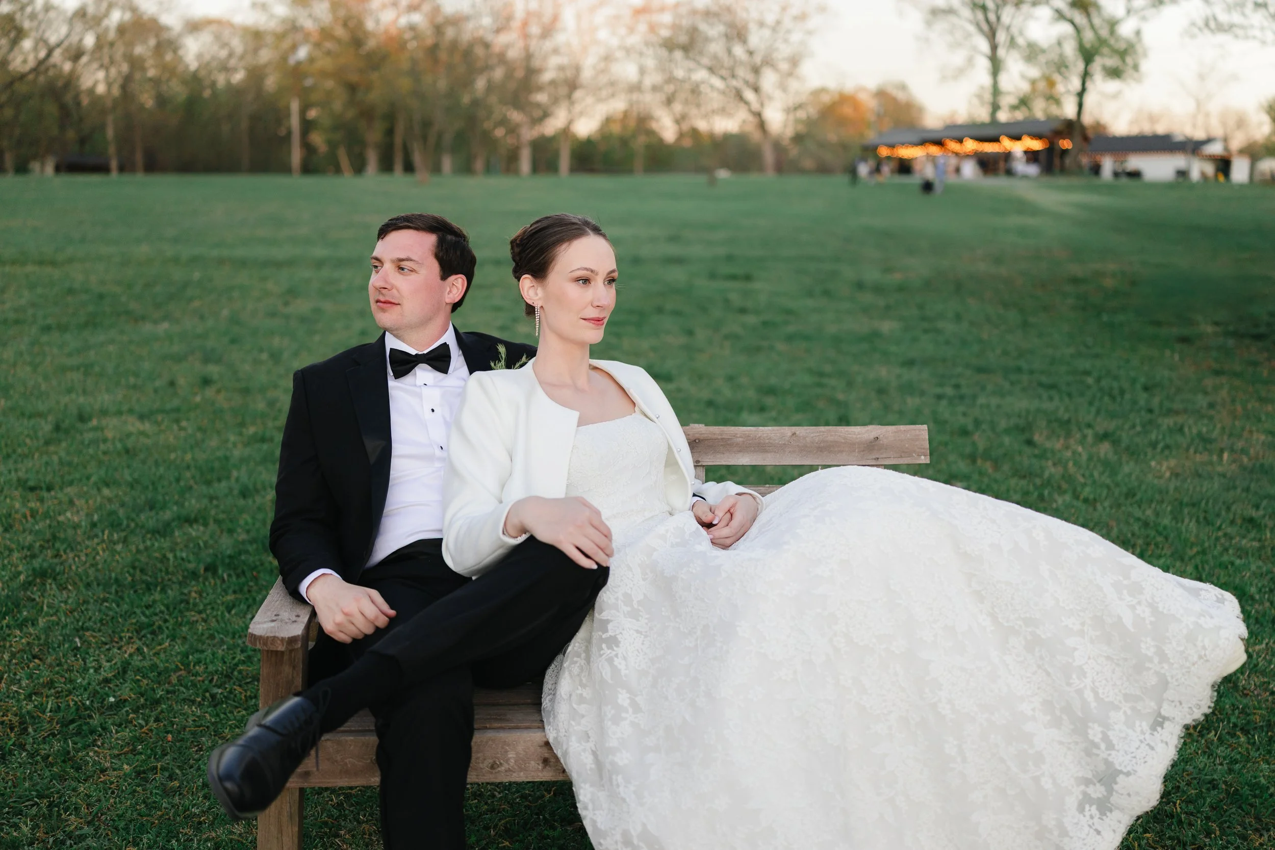 Editorial Wedding Photograph at the Union Exchange by Charlotte wedding photoas her groom admires her other at sunset overlooking Uptown Charlotte skyline on rooftop of Kingston South End by Charlotte wedding photographer Michael Parks, ParksPictures