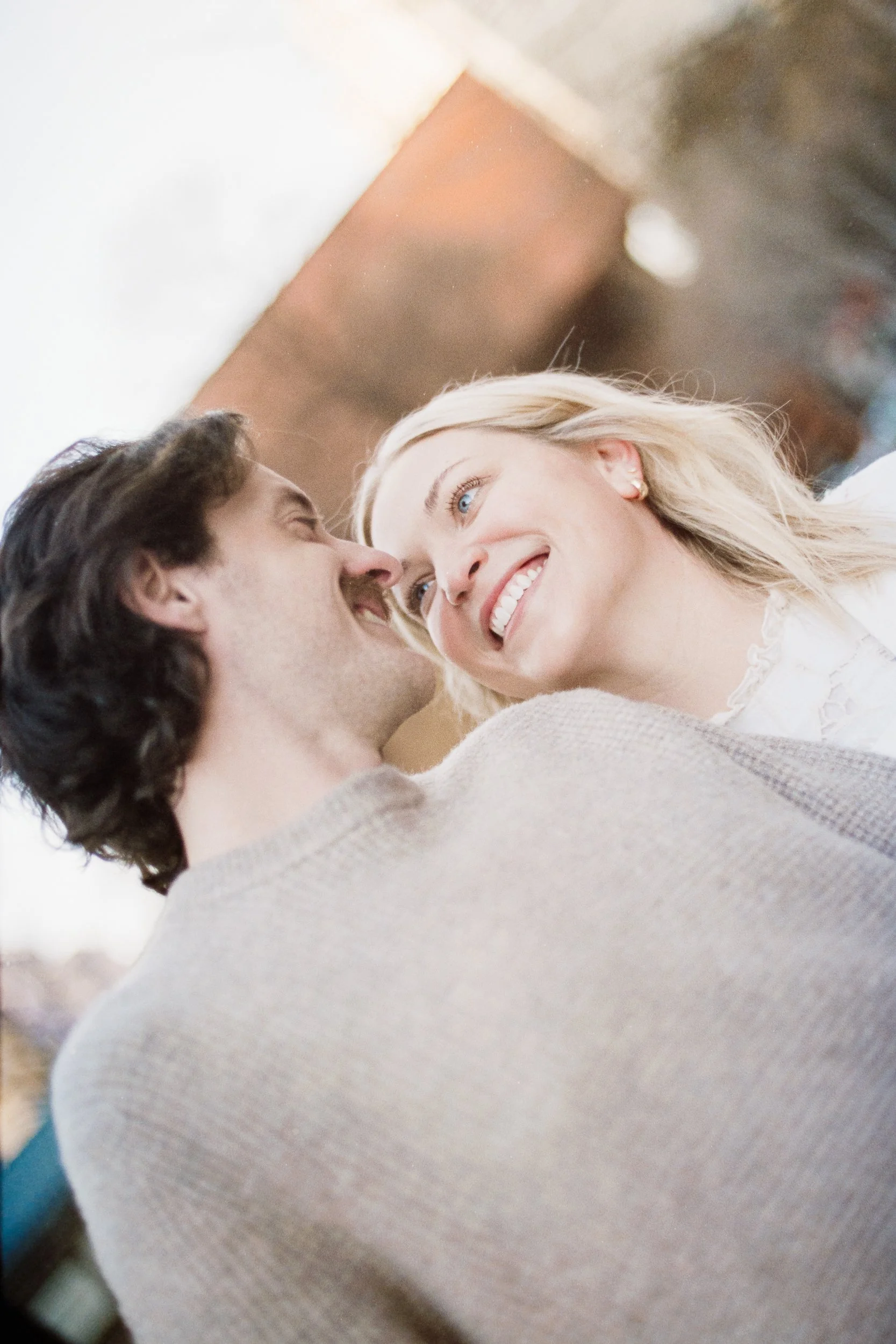 Film Engagement Photos on The Green Uptown Charlotte St Peter Catholic Church by wedding photographer ParksPictures