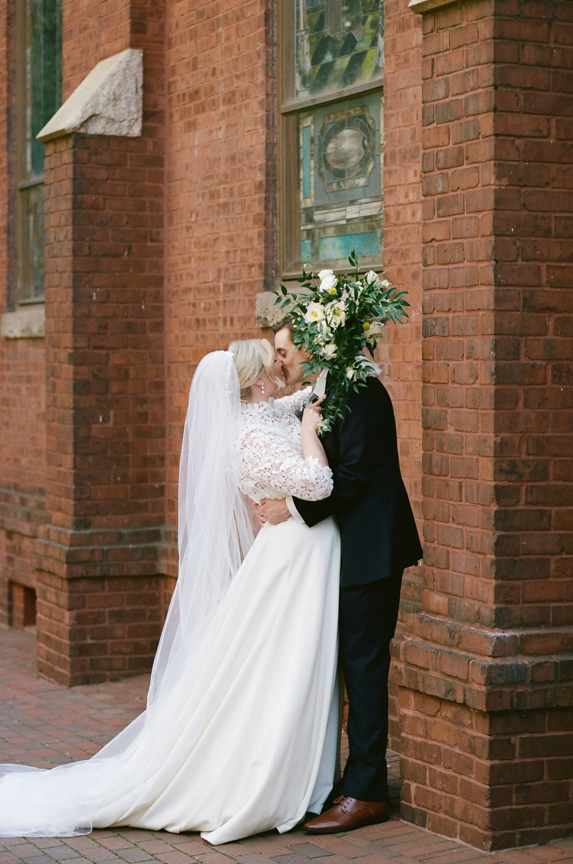 Bride and Groom on Portra 400 film after Catholic wedding sacrament Mass at St. Peter Catholic Church in Uptown Charlotte NC