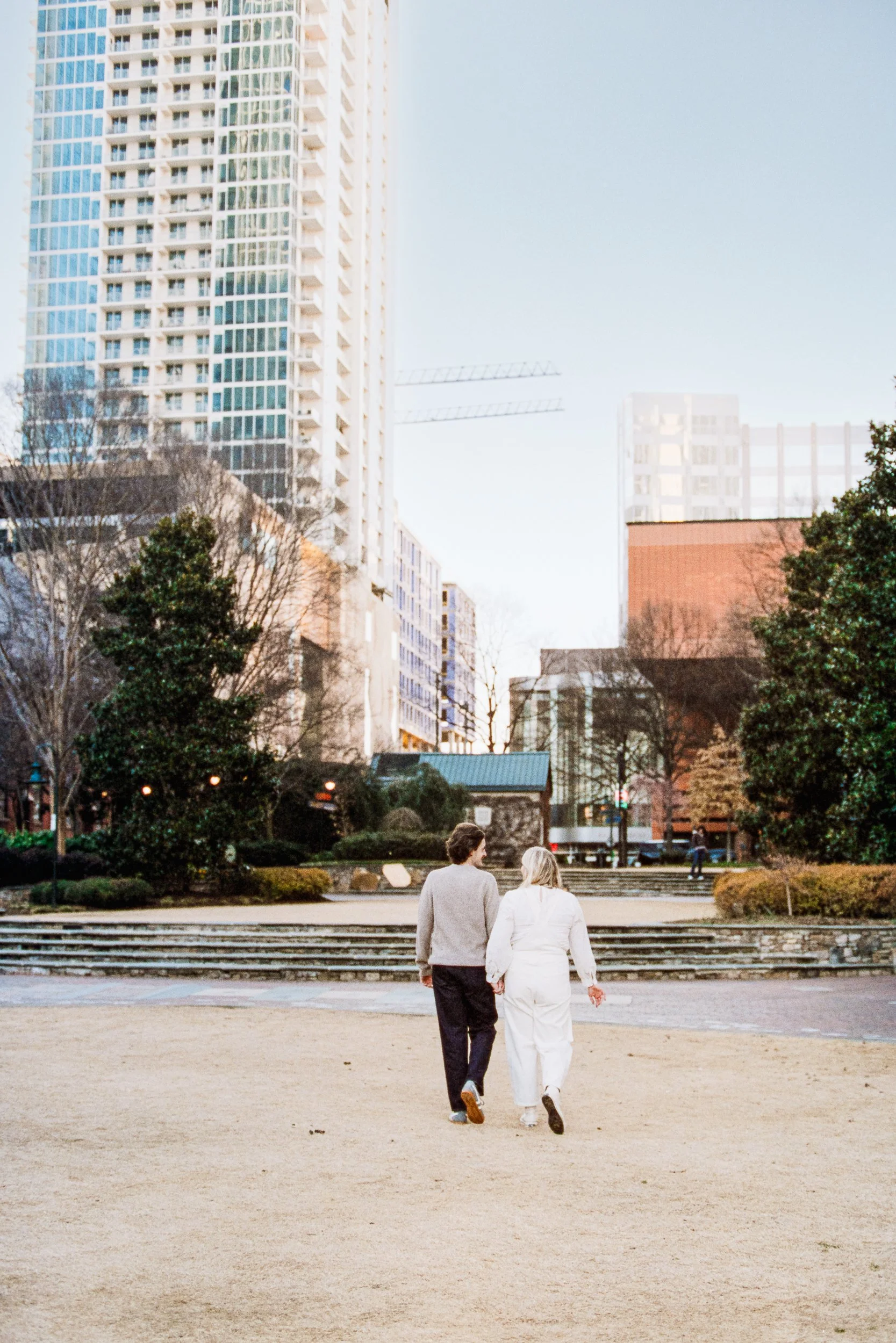 Film Engagement Photos on The Green Uptown Charlotte St Peter Catholic Church by wedding photographer ParksPictures