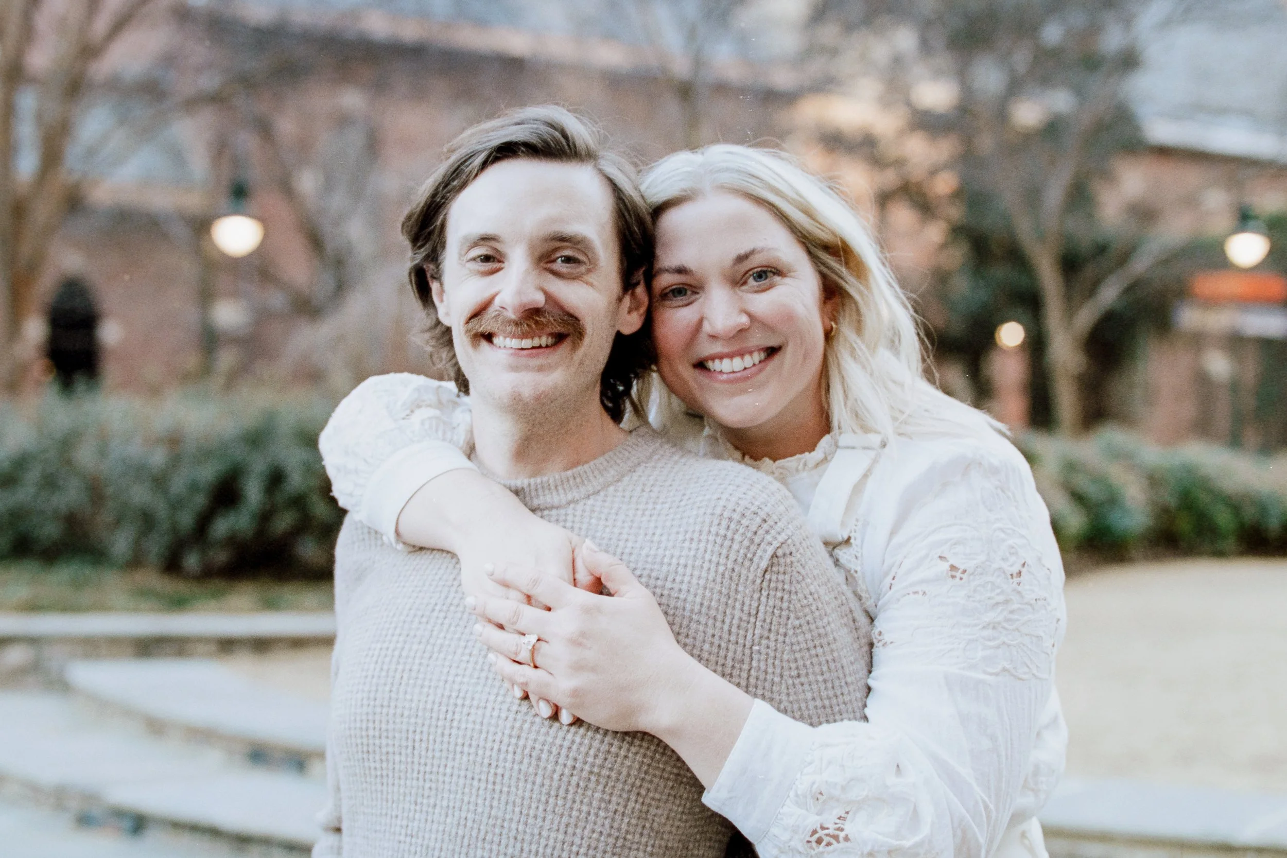 Film Engagement Photos on The Green Uptown Charlotte St Peter Catholic Church by wedding photographer ParksPictures