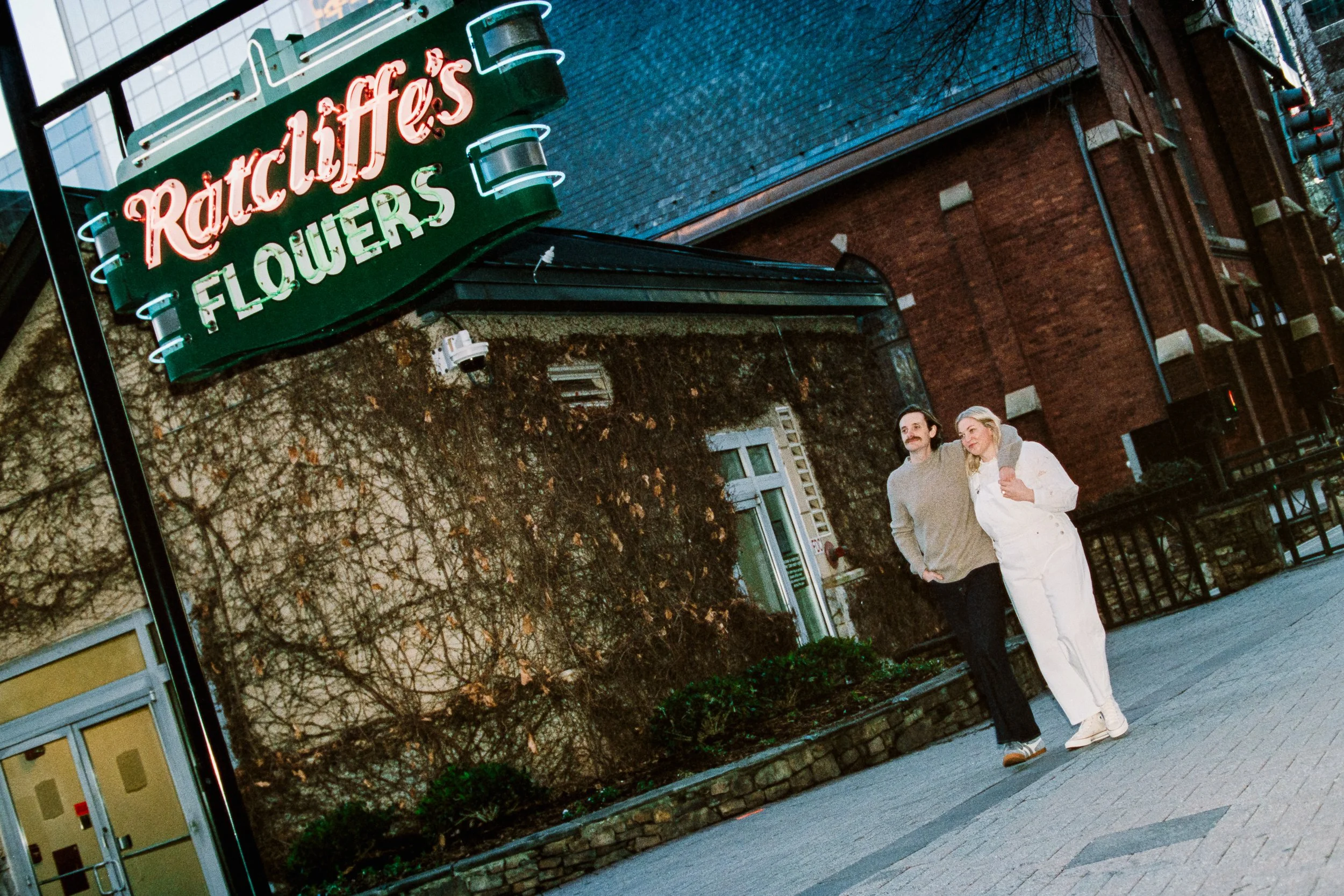 Film Engagement Photos on The Green Uptown Charlotte St Peter Catholic Church by wedding photographer ParksPictures