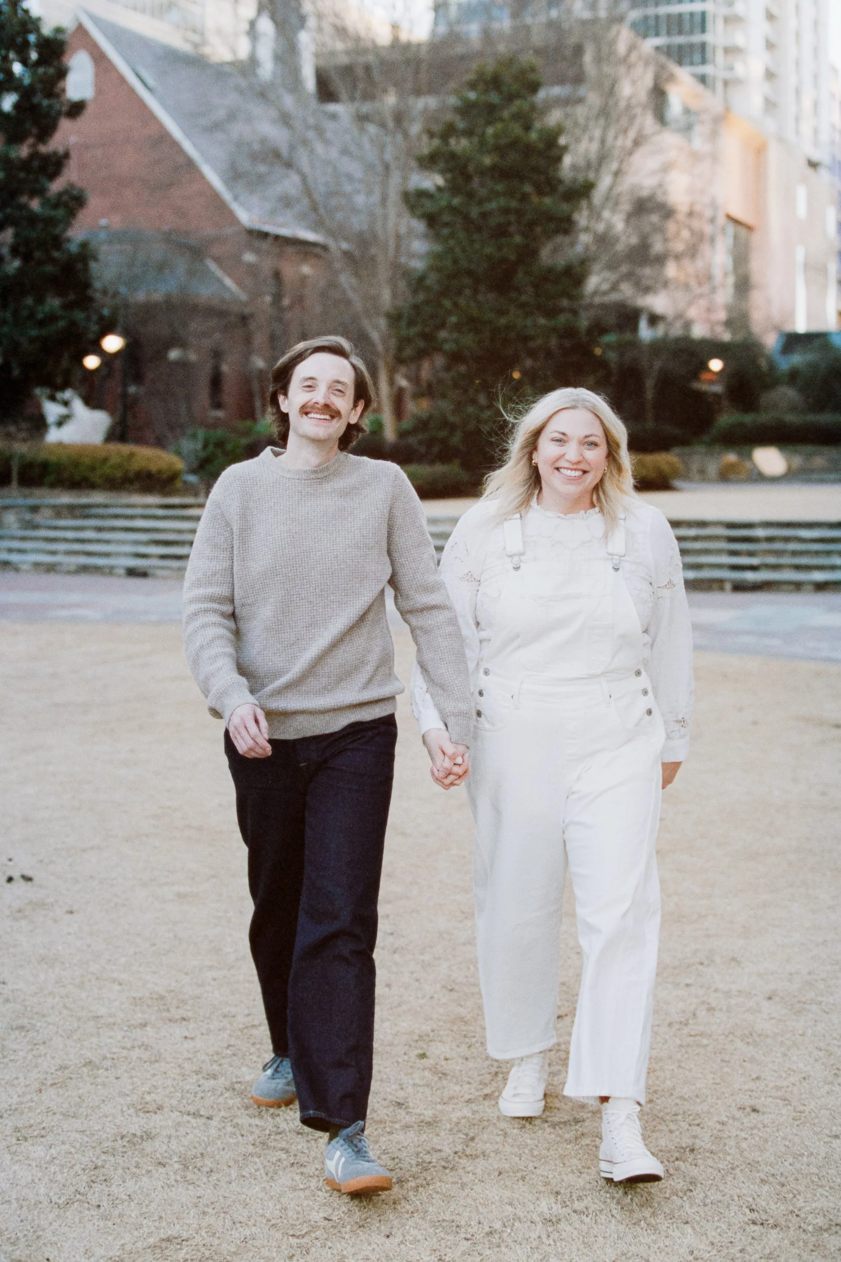 Film Engagement Photos on The Green Uptown Charlotte St Peter Catholic Church by wedding photographer ParksPictures