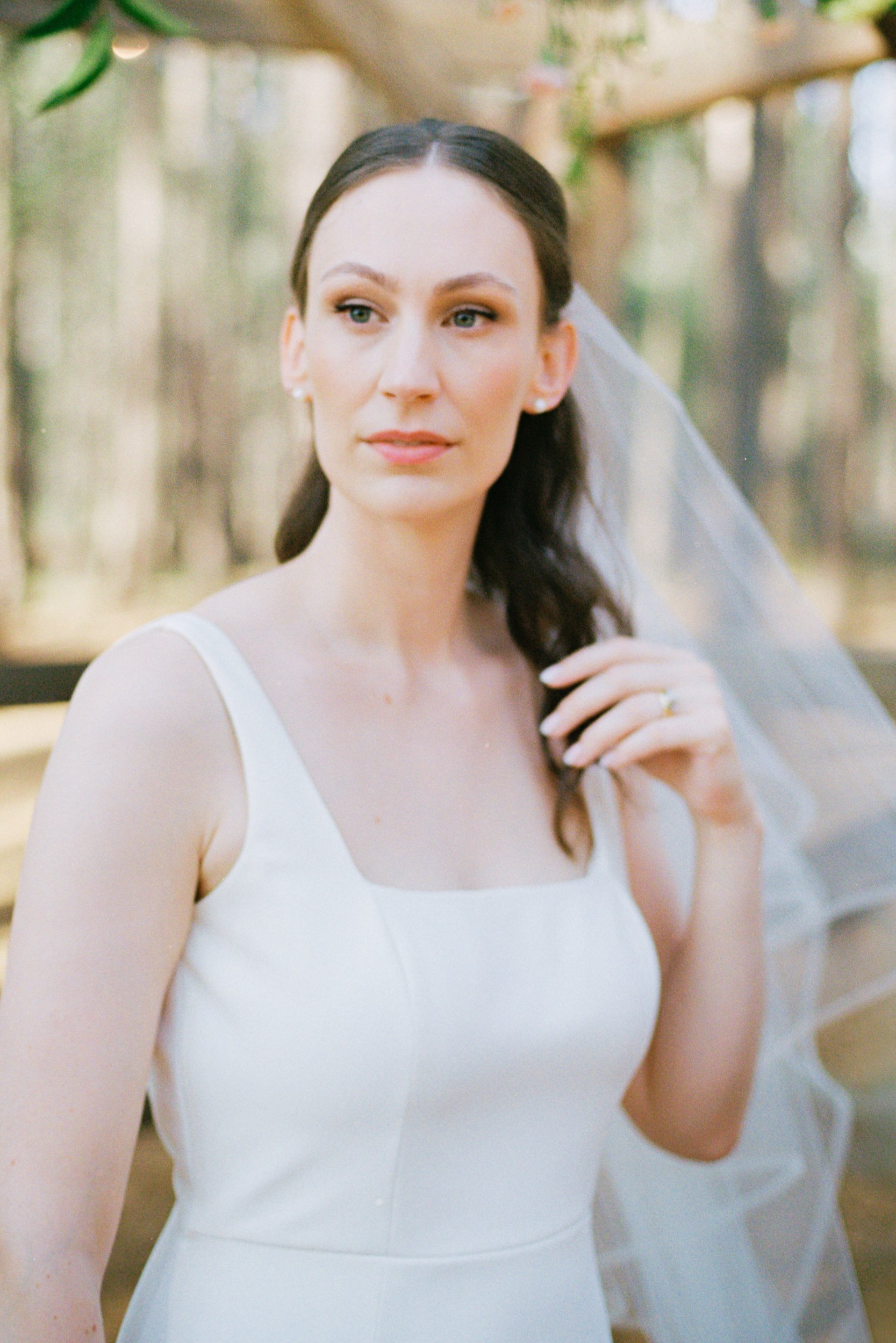 Editorial Film Wedding Photo at the Union Exchange by Charlotte wedding photoas her groom admires her other at sunset overlooking Uptown Charlotte skyline on rooftop of Kingston South End by Charlotte wedding photographer Michael Parks, ParksPictures