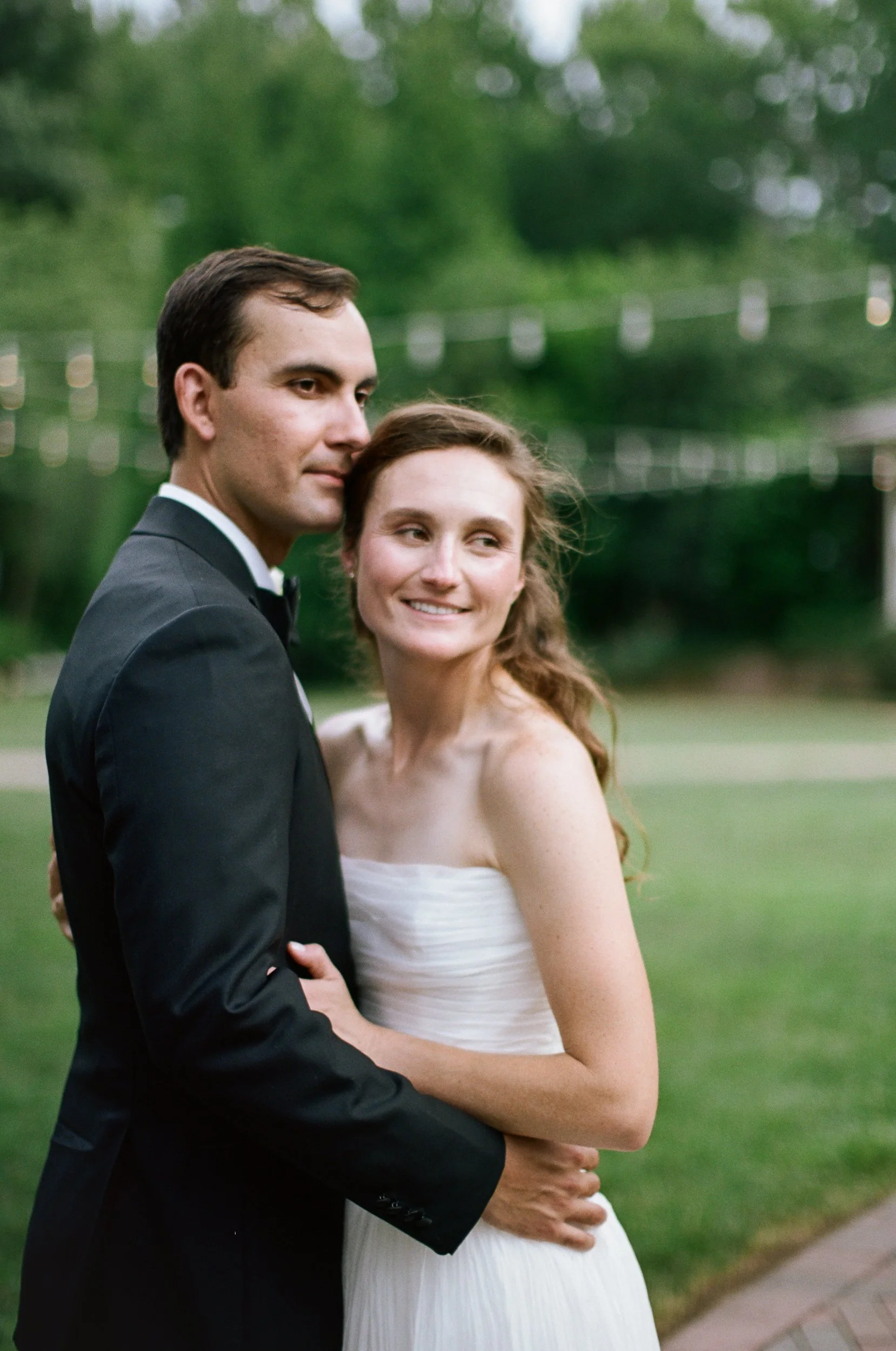 Film photos of bride and groom posing outside at St Gabriel Catholic Church and Alexander Homestead in Charlotte NC by Charlotte Film Wedding Photographer Michael Parks, ParksPictures