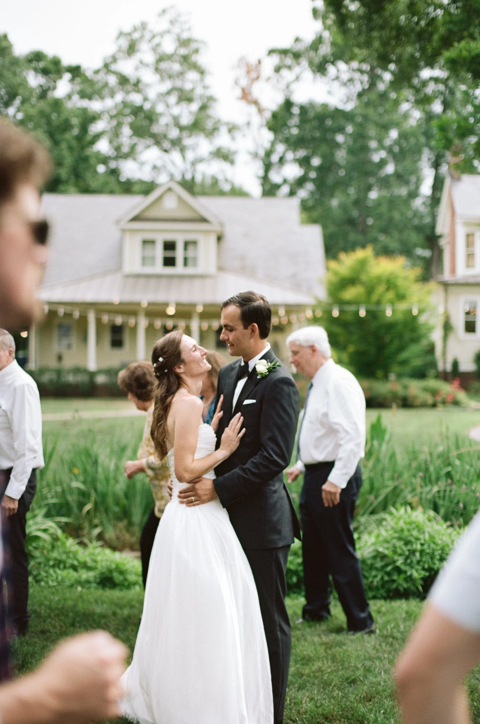 Blurry film pictures of bride and groom posing outside at St Gabriel Catholic Church and Alexander Homestead in Charlotte NC by Charlotte Film Wedding Photographer Michael Parks, ParksPictures