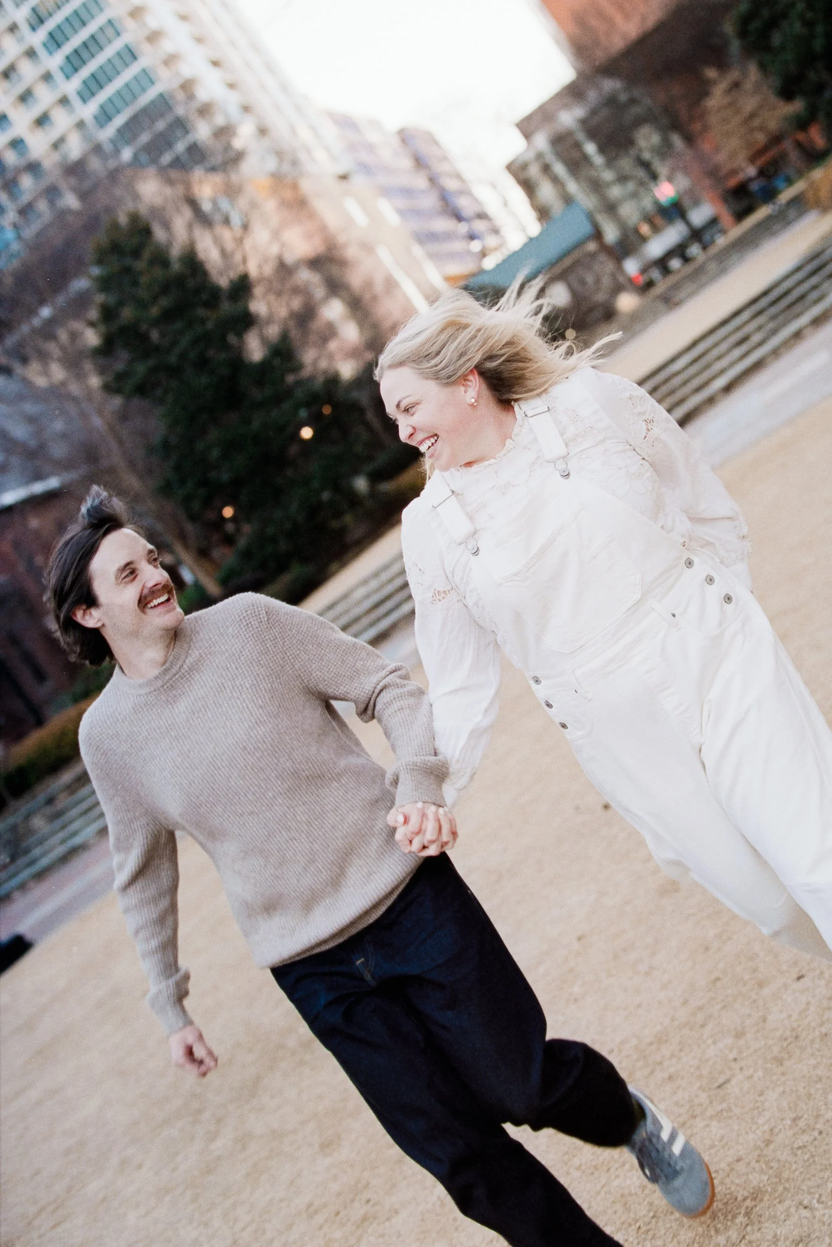 Film Engagement Photos on The Green Uptown Charlotte St Peter Catholic Church by wedding photographer ParksPictures