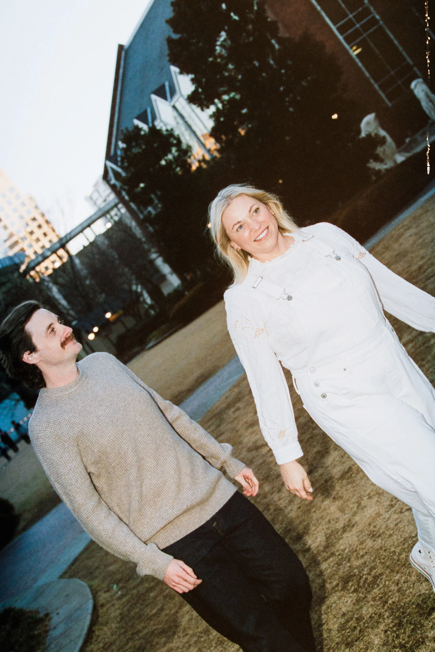 Film Engagement Photos on The Green Uptown Charlotte St Peter Catholic Church by wedding photographer ParksPictures