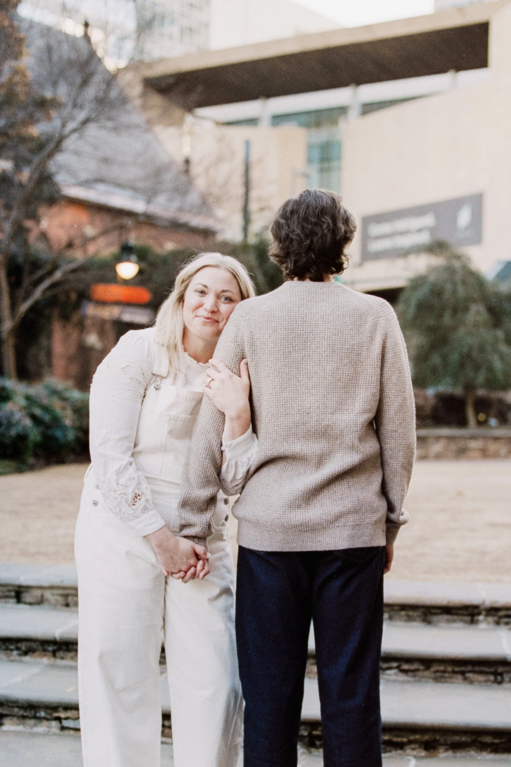 Film Engagement Photos on The Green Uptown Charlotte St Peter Catholic Church by wedding photographer ParksPictures