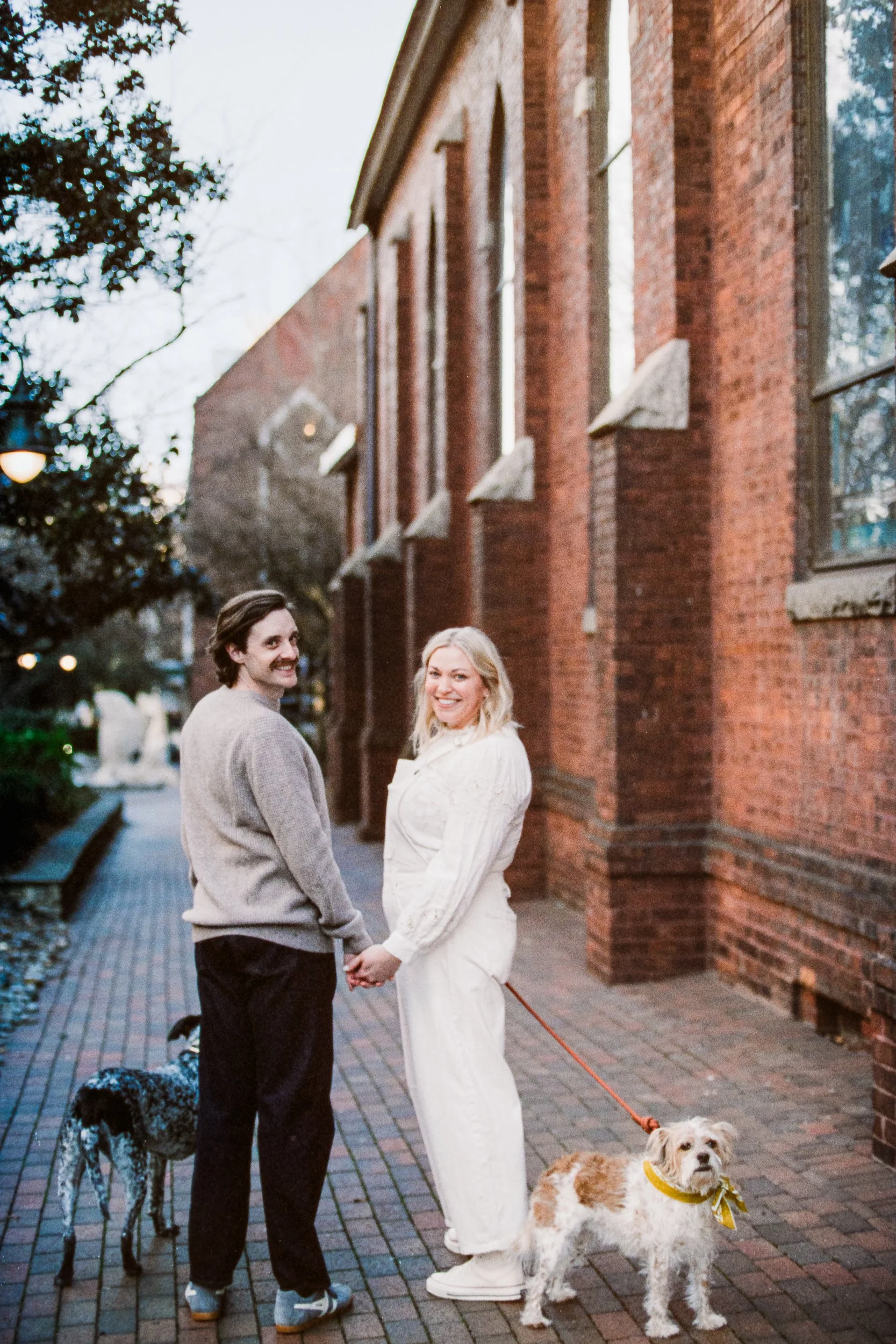 Film Engagement Photos on The Green Uptown Charlotte St Peter Catholic Church by wedding photographer ParksPictures
