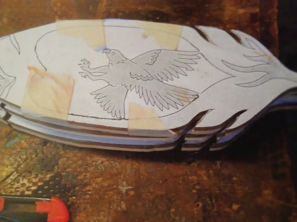 Stacking the woods with a pattern glued to the top allowed Jerry to cut 2 or 3 feathers at a time.