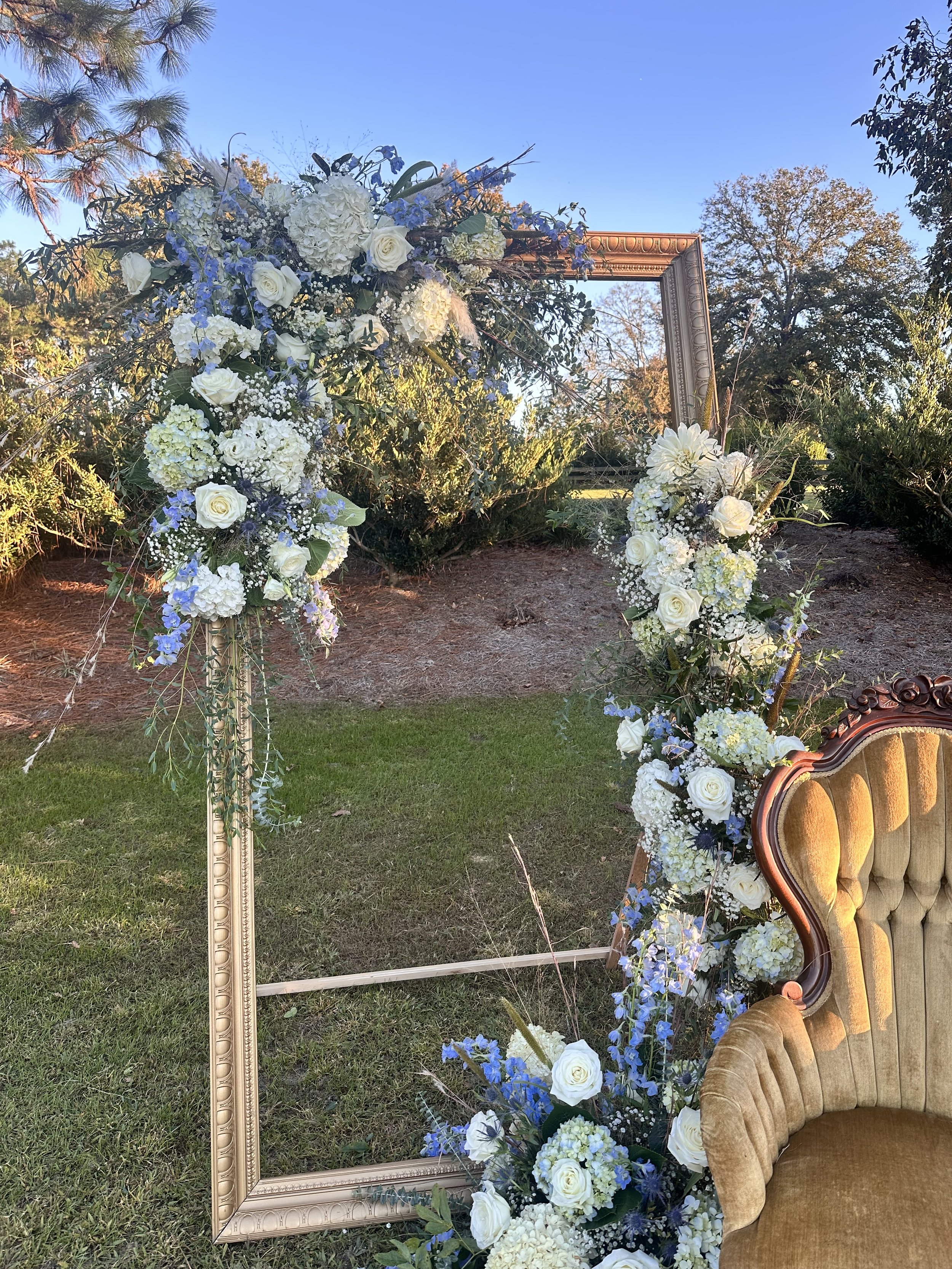 Photo backdrop, white and blue wedding florals