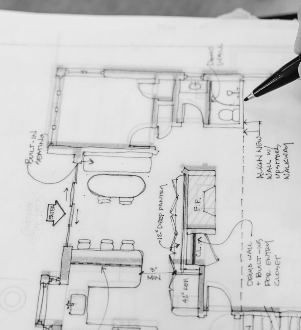 Hand-drawn floor plan of a house showing rooms, doors, and furniture. Notes indicate construction details and measurements.