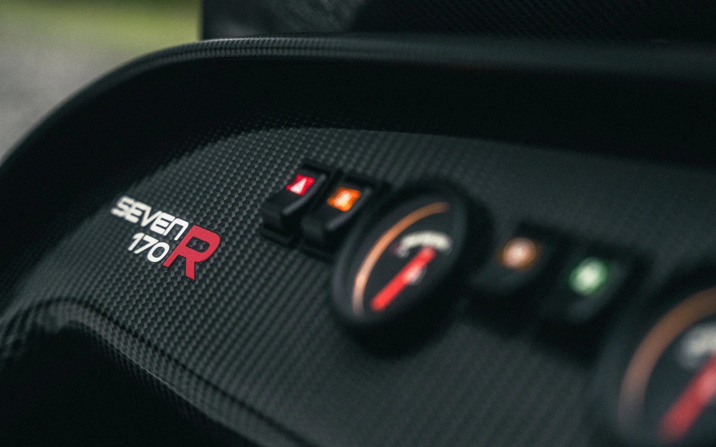 Close-up of the dashboard of a Subaru WRX STI, featuring the logo, gauges, and indicator lights.