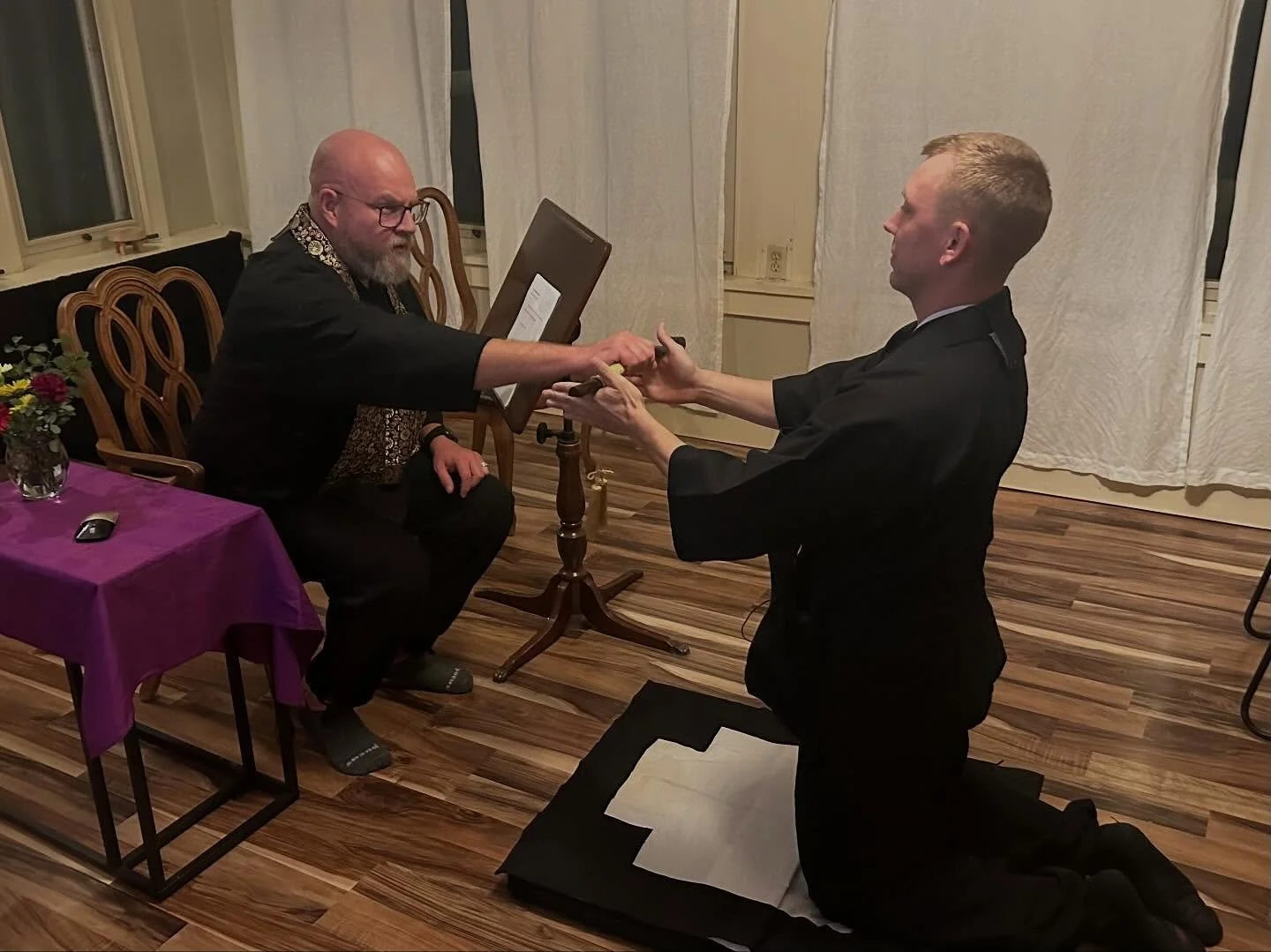 During the 2025 Ango at One River Zen, Genpo Seth Myers received the kotsu from Sensei Michael Brunner to begin leading his first class. The kotsu is held provisionally and returned after each teaching — a reminder of the tremendous responsibil