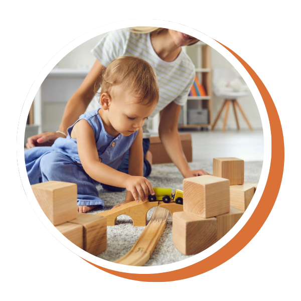 toddler and caregiver playing with wood toys