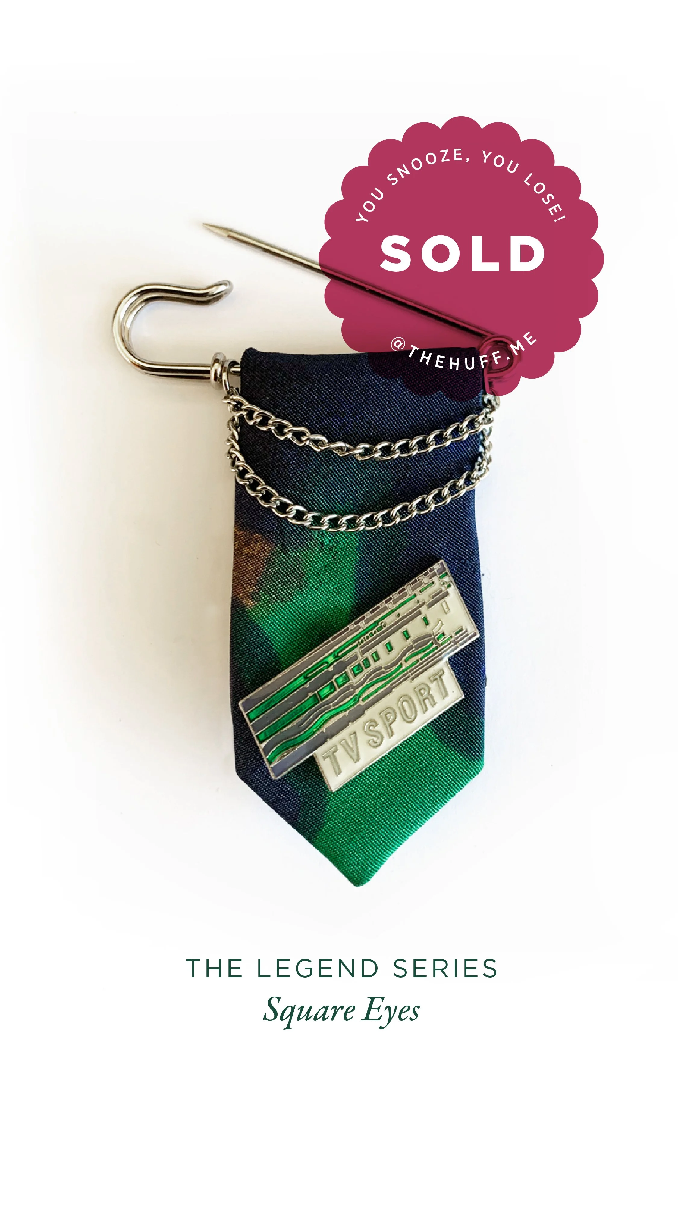 TV sports award on a colorful fabric with a chain, a small pin, and a Snooze sticker that says 'Sold'