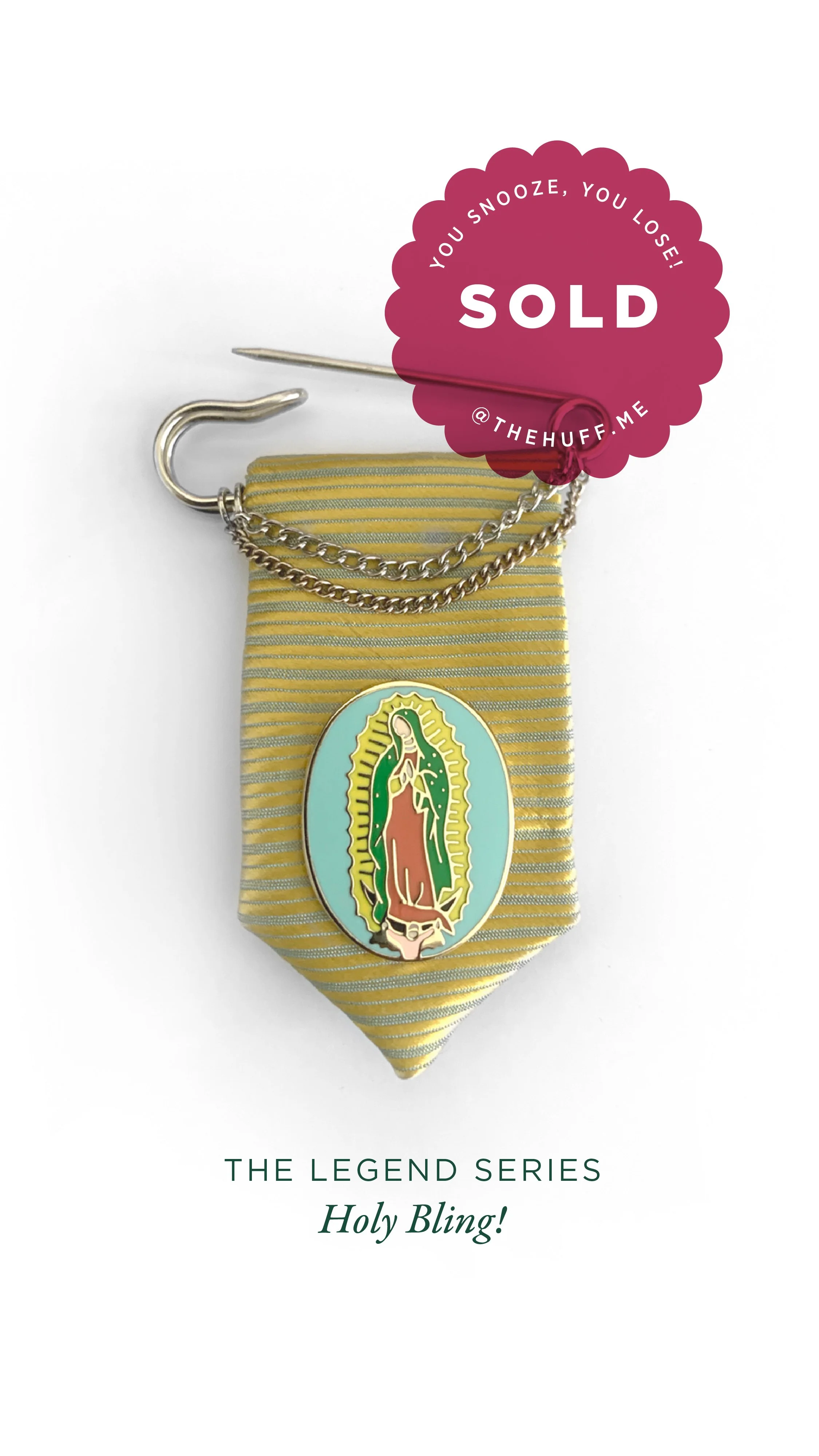 A religious pin of Our Lady of Guadalupe attached to a yellow striped fabric with a silver chain and pin, and a pink sold tag with the words "You snooze, you lose!" and the website "@thehuff.me."