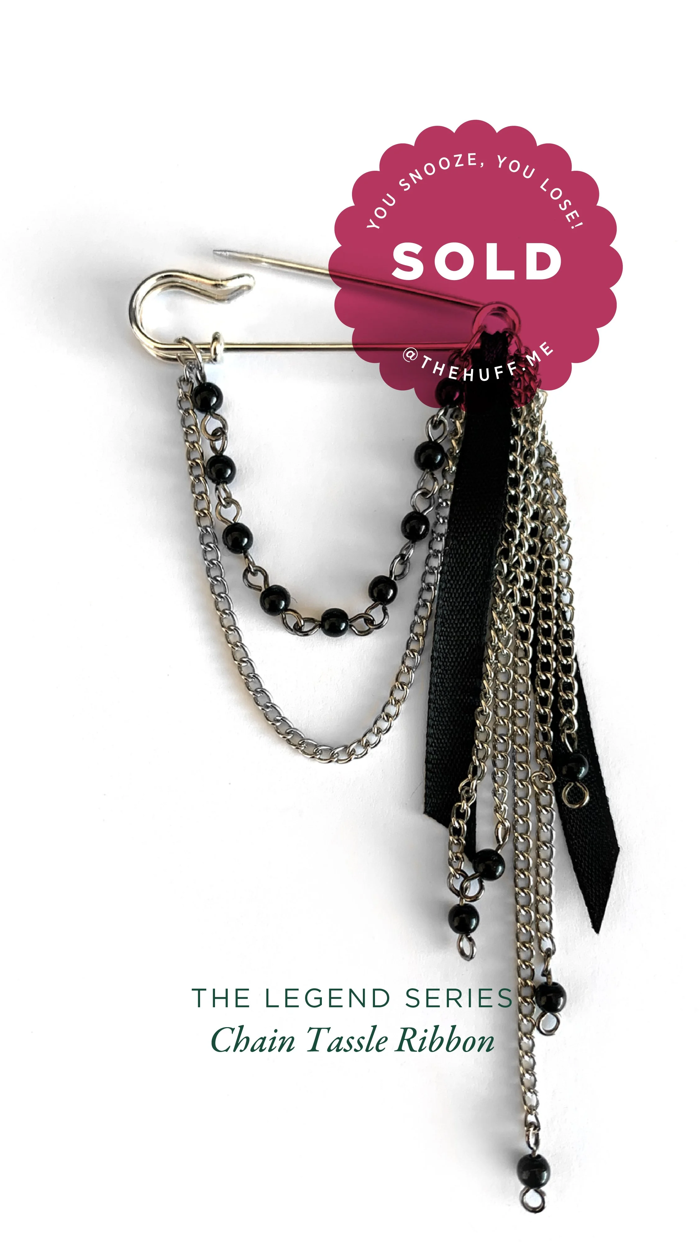 Fashion jewellery pin with layered chains, black beads, and ribbons, from The Legend Series Chain Tassle Ribbon collection, with sold sticker.