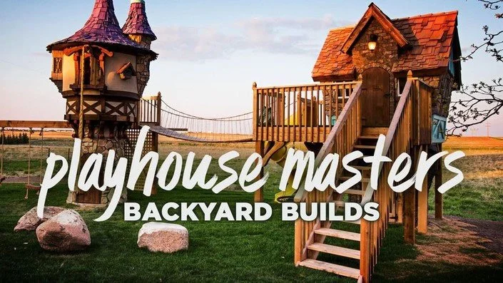 A large wooden backyard playhouse with towers, a bridge, and slides, situated on a grassy yard at sunset, with the text 'playhouse masters BACKYARD BUILDS' overlaid.