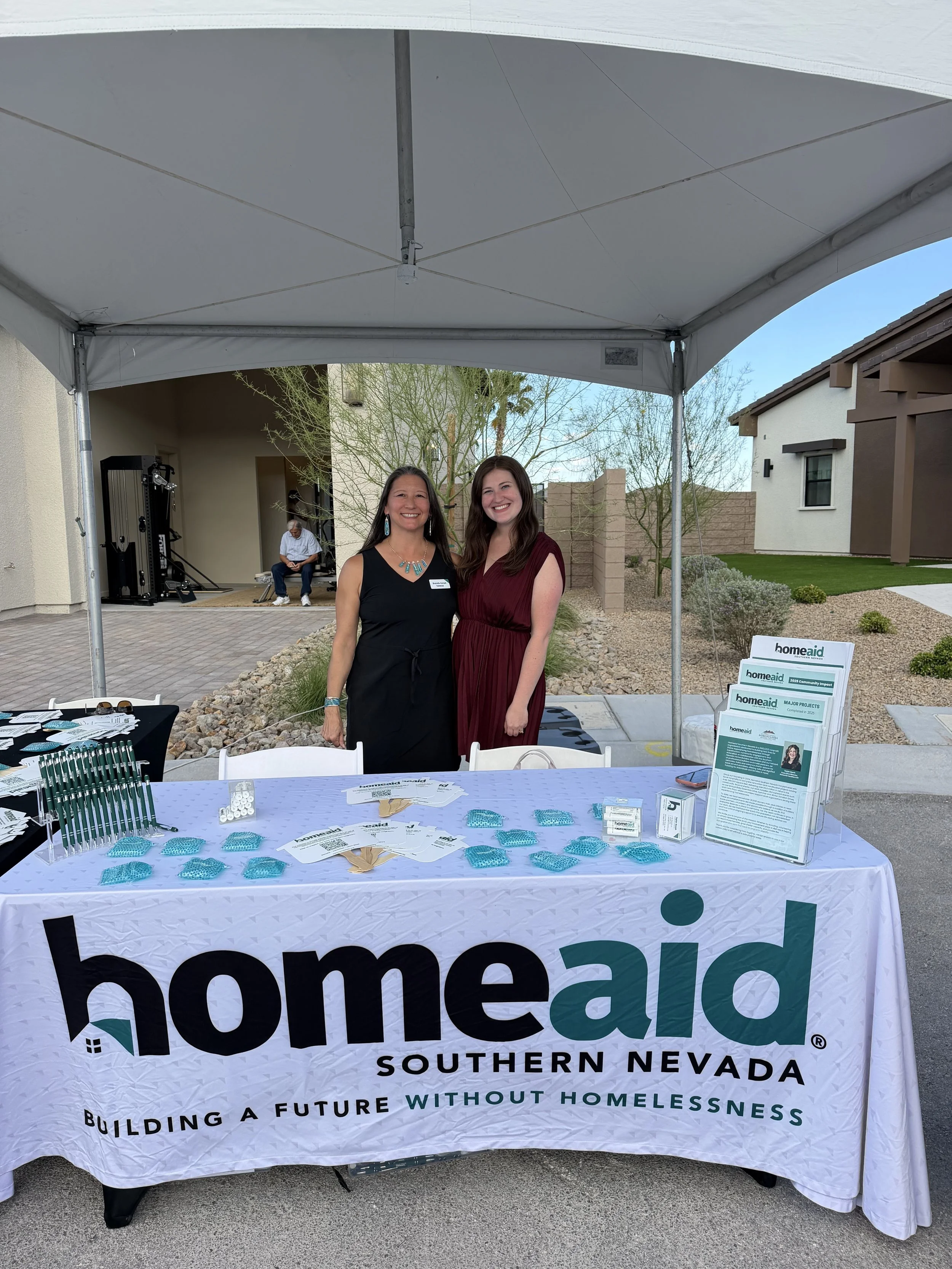 Brenda and Taylor behind of a HomeAid Southern Nevada table