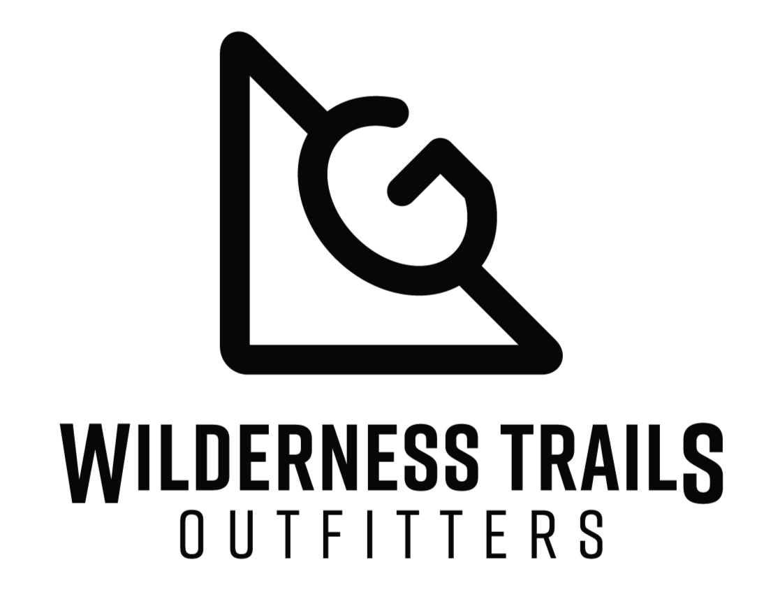 A black and white logo for Wilderness Trails Outfitters with a mountain and trail marker symbol.