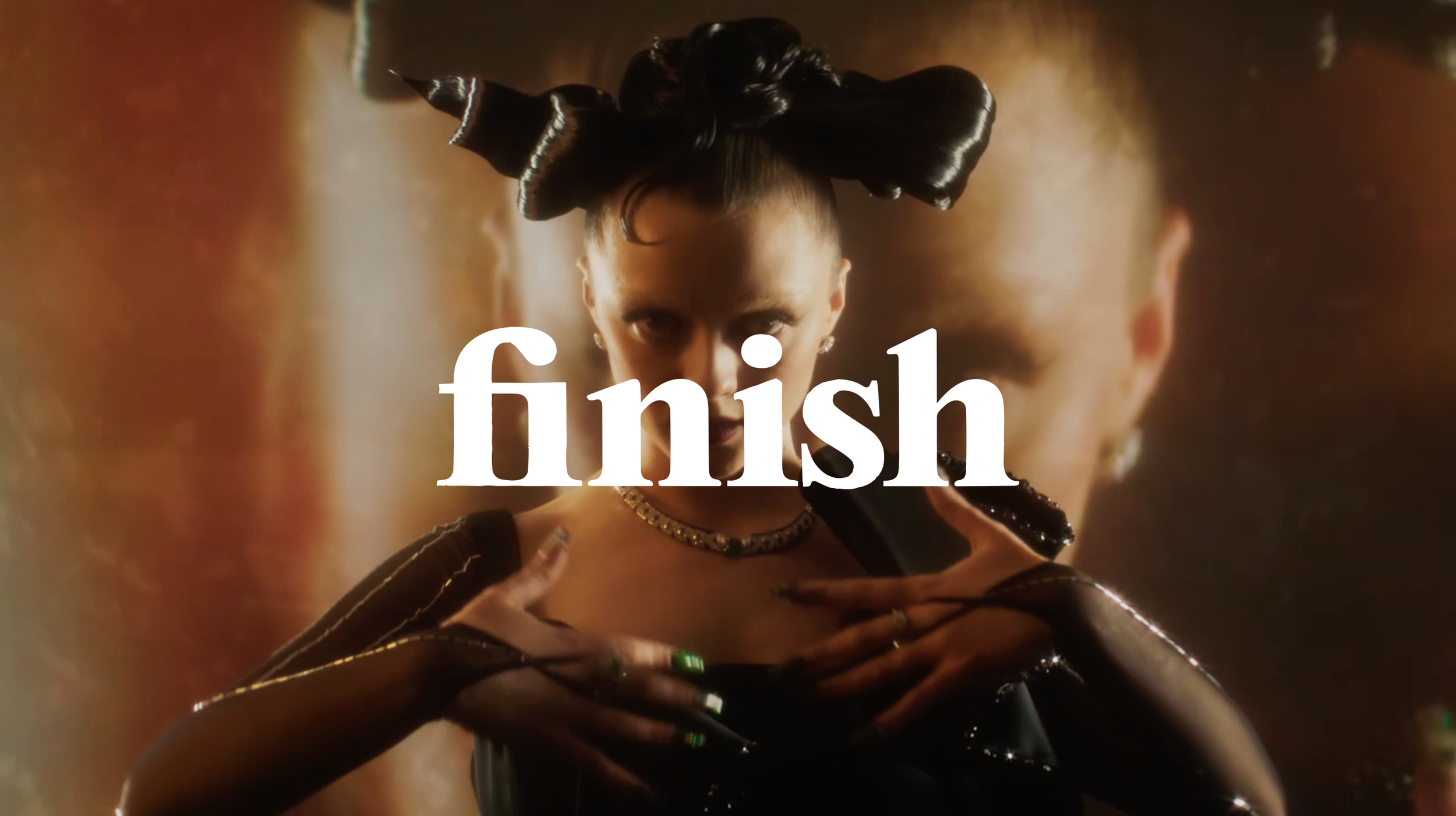 A woman with styled black hair and tattoos, wearing jewelry, looking directly at the camera, with the word 'finish' overlaid. Cartier Met Gala.