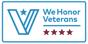 Sign with the Veterans of Foreign Wars logo and the text 'We Honor Veterans' with four red stars.