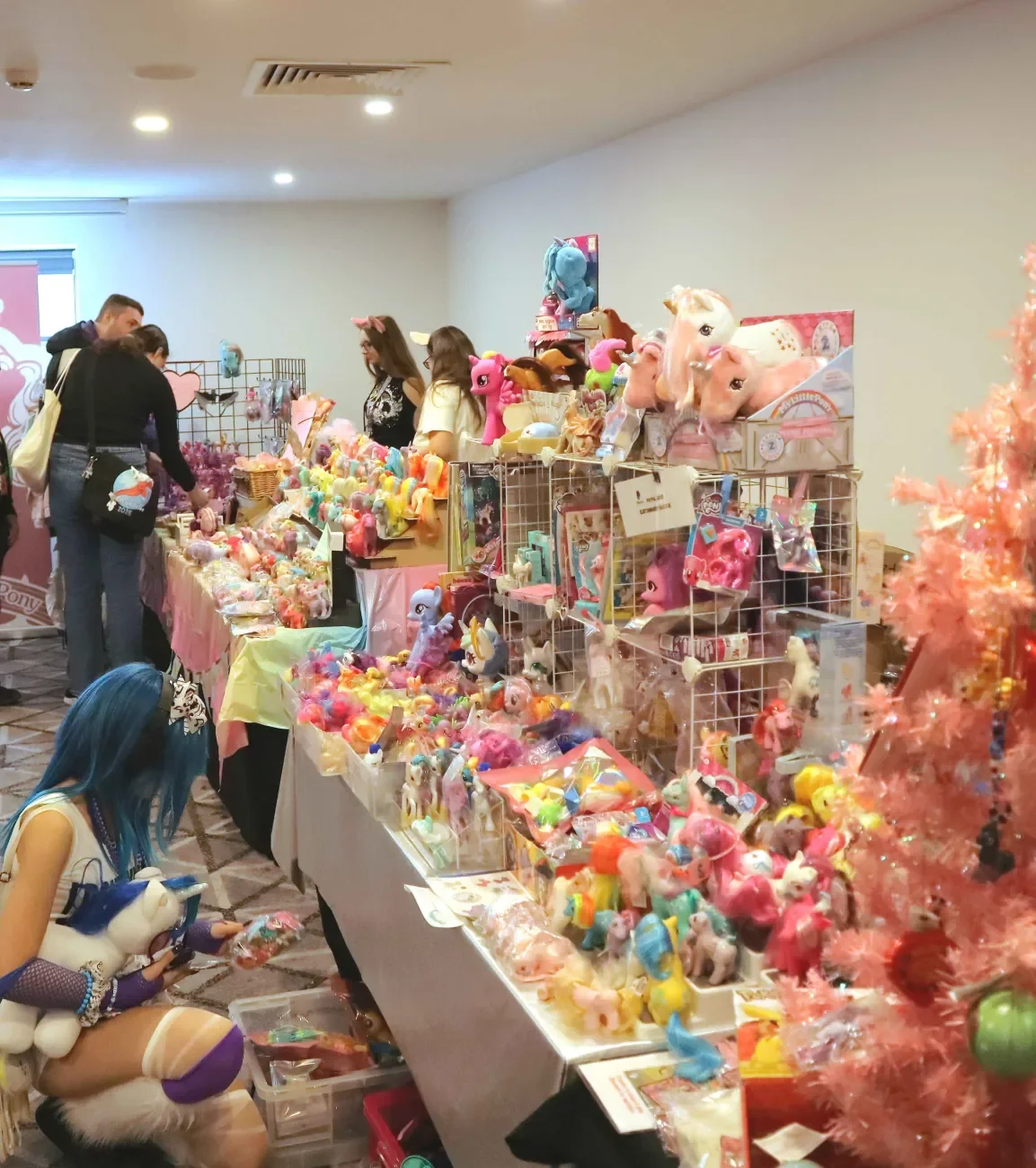 Photo of an overflowing stall of ponies at UK PonyCon 2025