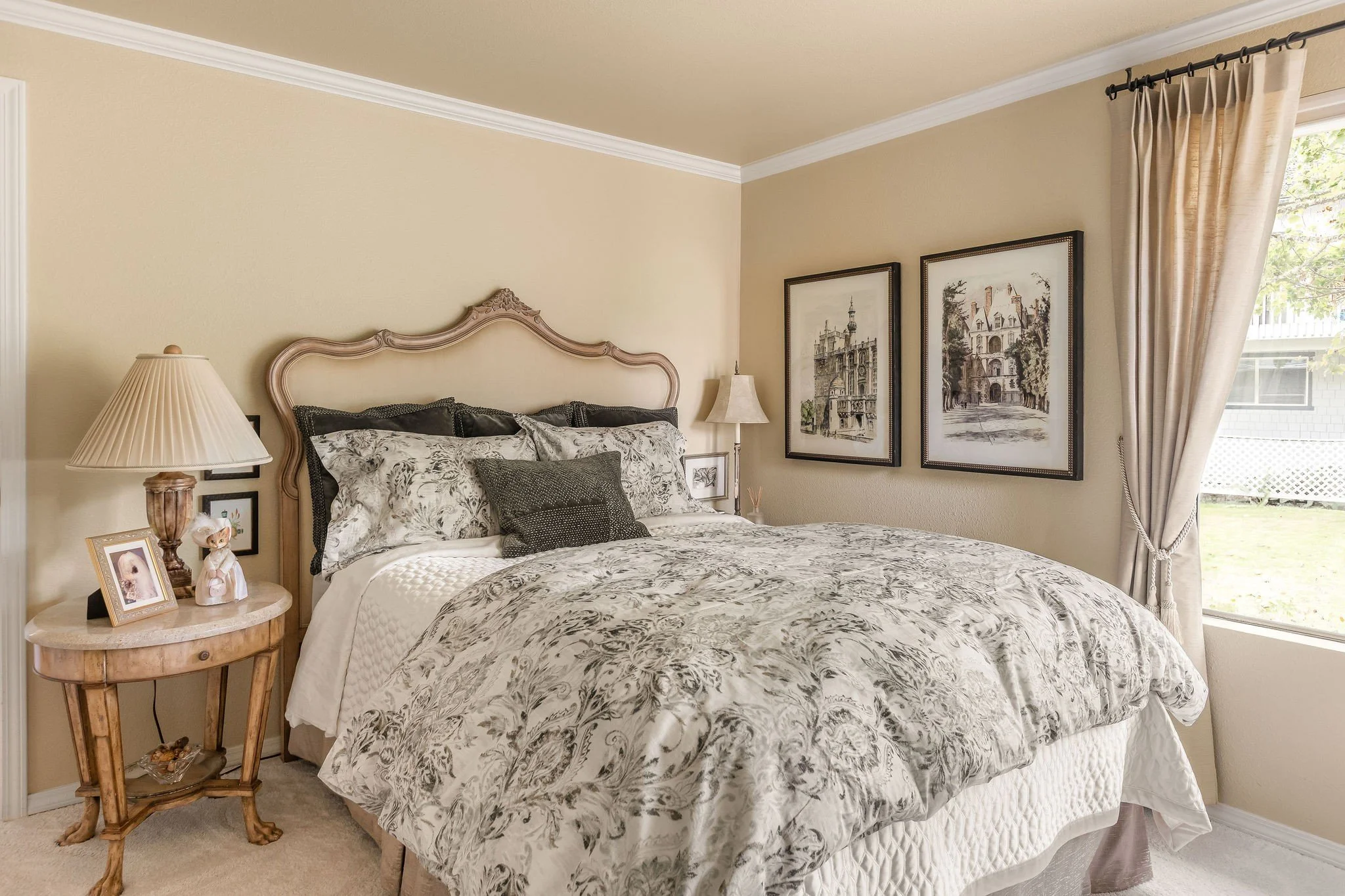 This Redmond guest bedroom was transformed through a thoughtful no‑remodel refresh that honored the client’s favorite existing pieces while elevating the entire space with curated new additions. The carved wood bed, classic nightstands, and meaningfu