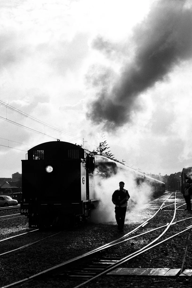 black and white railway photography fine art photo Taken by Scott Gould A Railway Life fine art photography steam engine WW644 and a volunteer backlit with steam and shining rails
