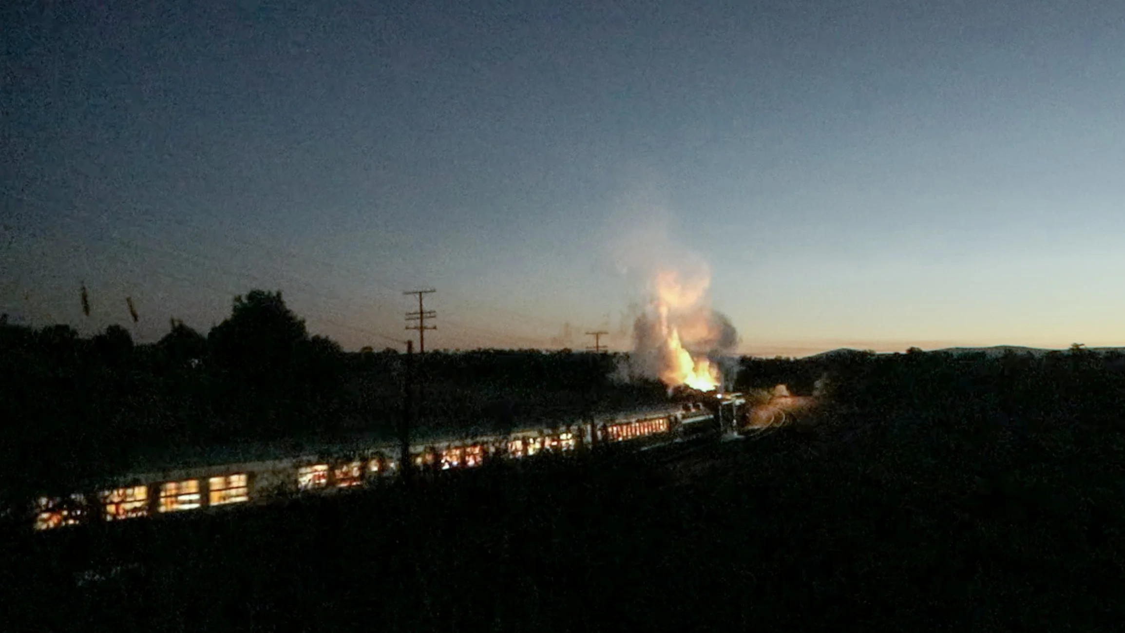 A still from a video of 3801 and its heritage train passing under Dirnaseer road bridge. the headlight of the train is reflecting on the rails, and glow from the fire is illuminating the exhaust. S.Gould A Railway Life photography